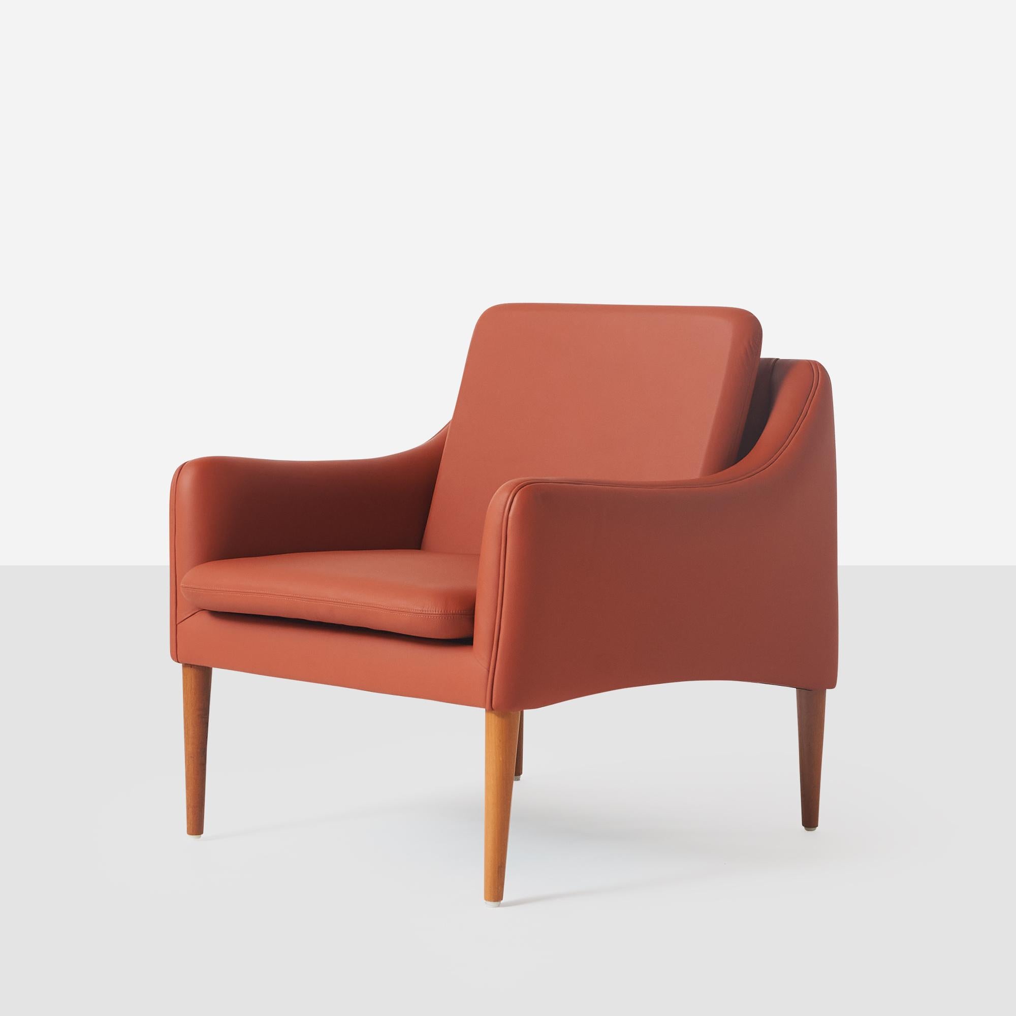 A series 800 club chair by Hans Olsen. The chair has been recovered in a persimmon colored leather.