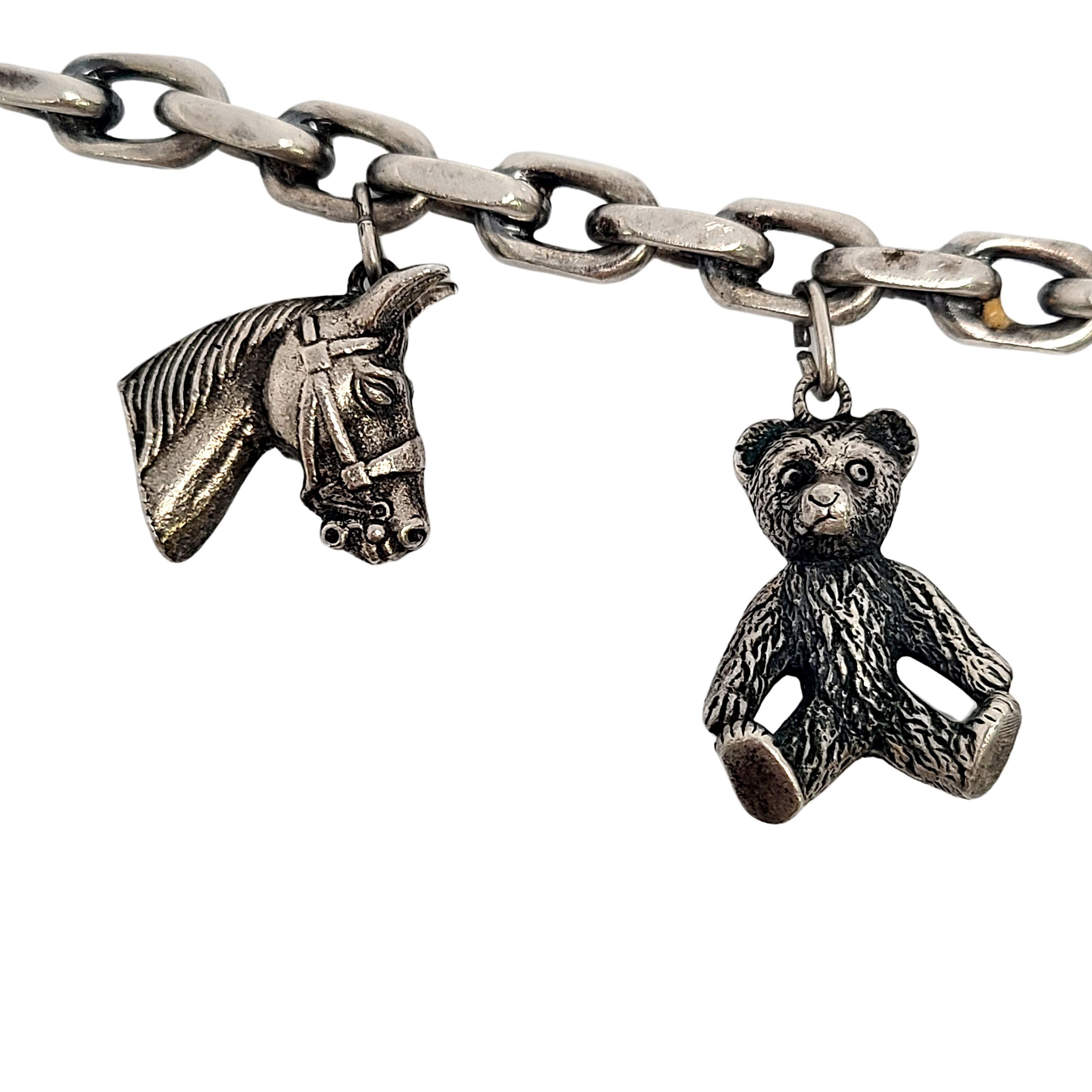 Vintage 800 silver charm bracelet.

Elongated oval link charm bracelet featuring 6 animal charms: horse head, teddy bear, swan, owl, monkey, and a piggy bank with a coin.

Measures approx 6 1/2