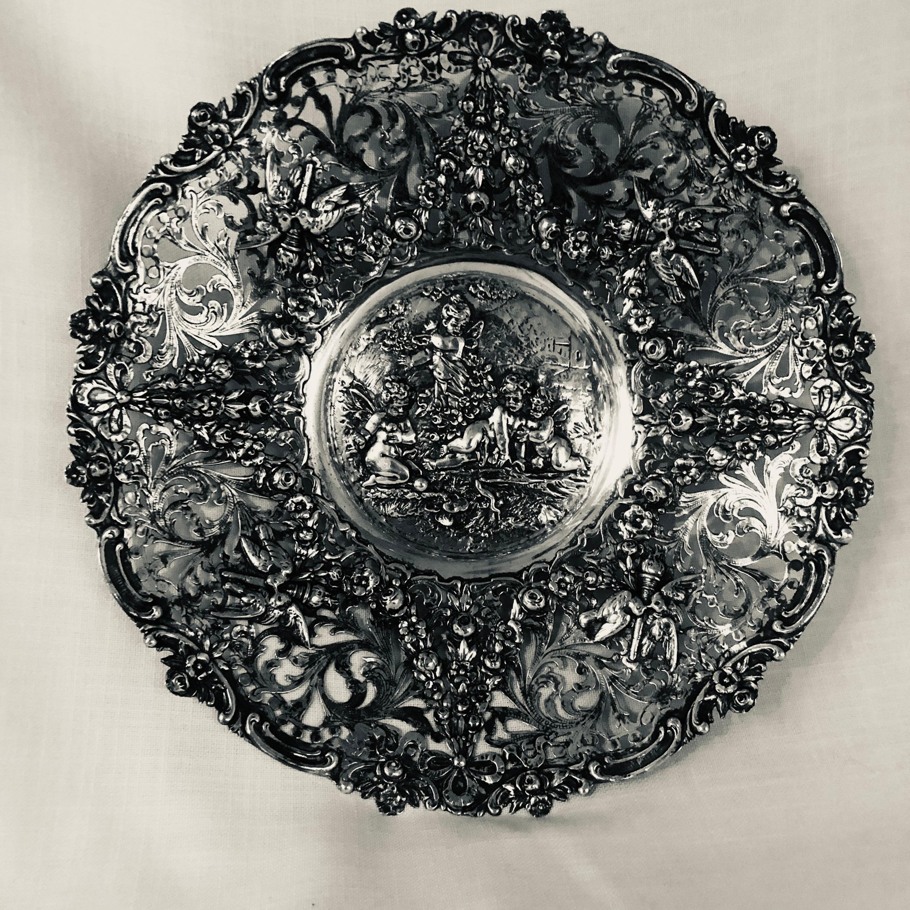 I am offering this fabulous openwork 800 silver large bowl to you. It is decorated with four raised cherubs in the center of the bowl. The profuse intricate reticulation on the sides of this silver bowl is decorated with garlands of flowers. On each