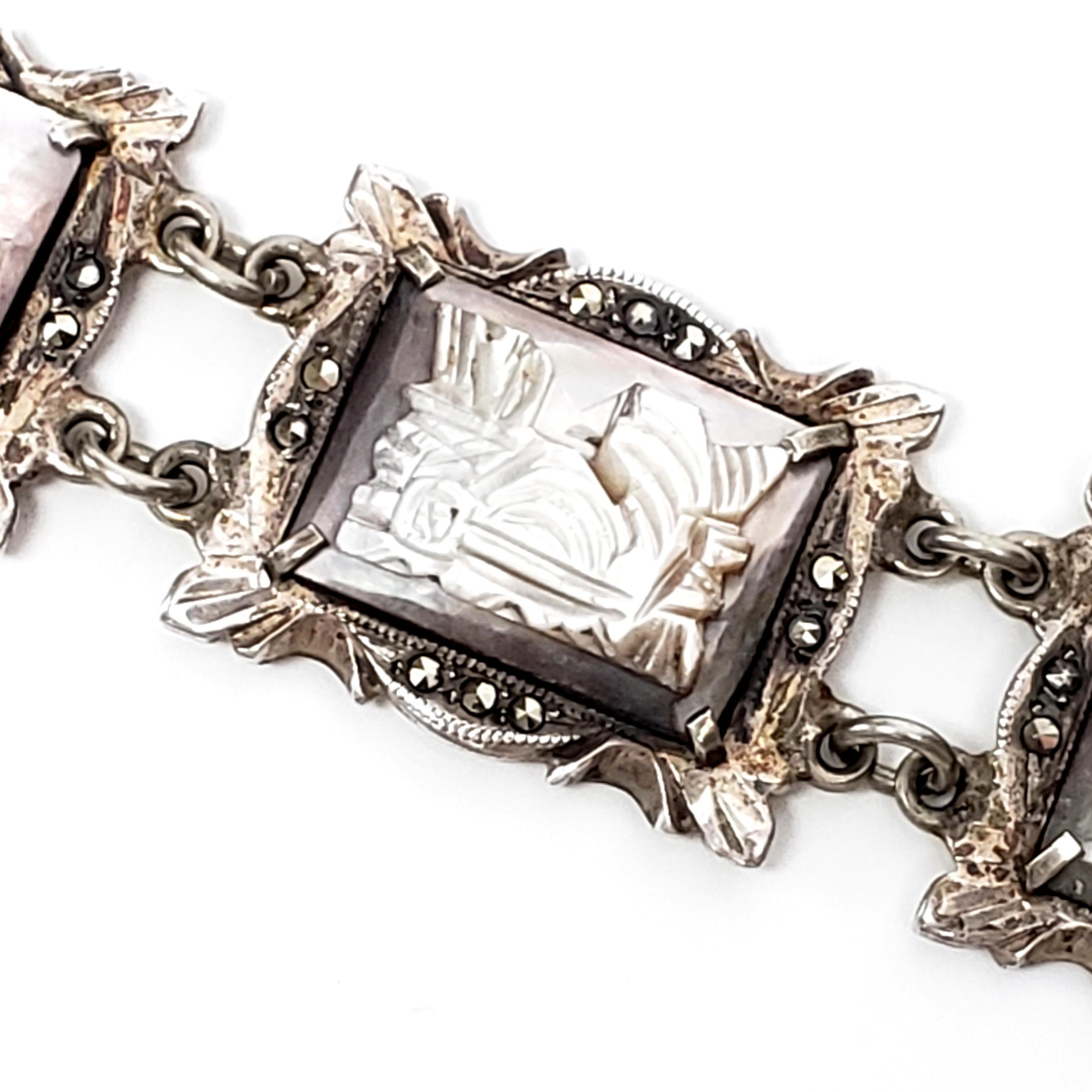 Vintage 800 silver, marcasite and carved abalone bracelet.

Abalone stones are carved into classic Roman chariot scenes, prong set on ornate silver frame links adorned with marcasite. Hidden slide closure.

Measures approx 7 3/4