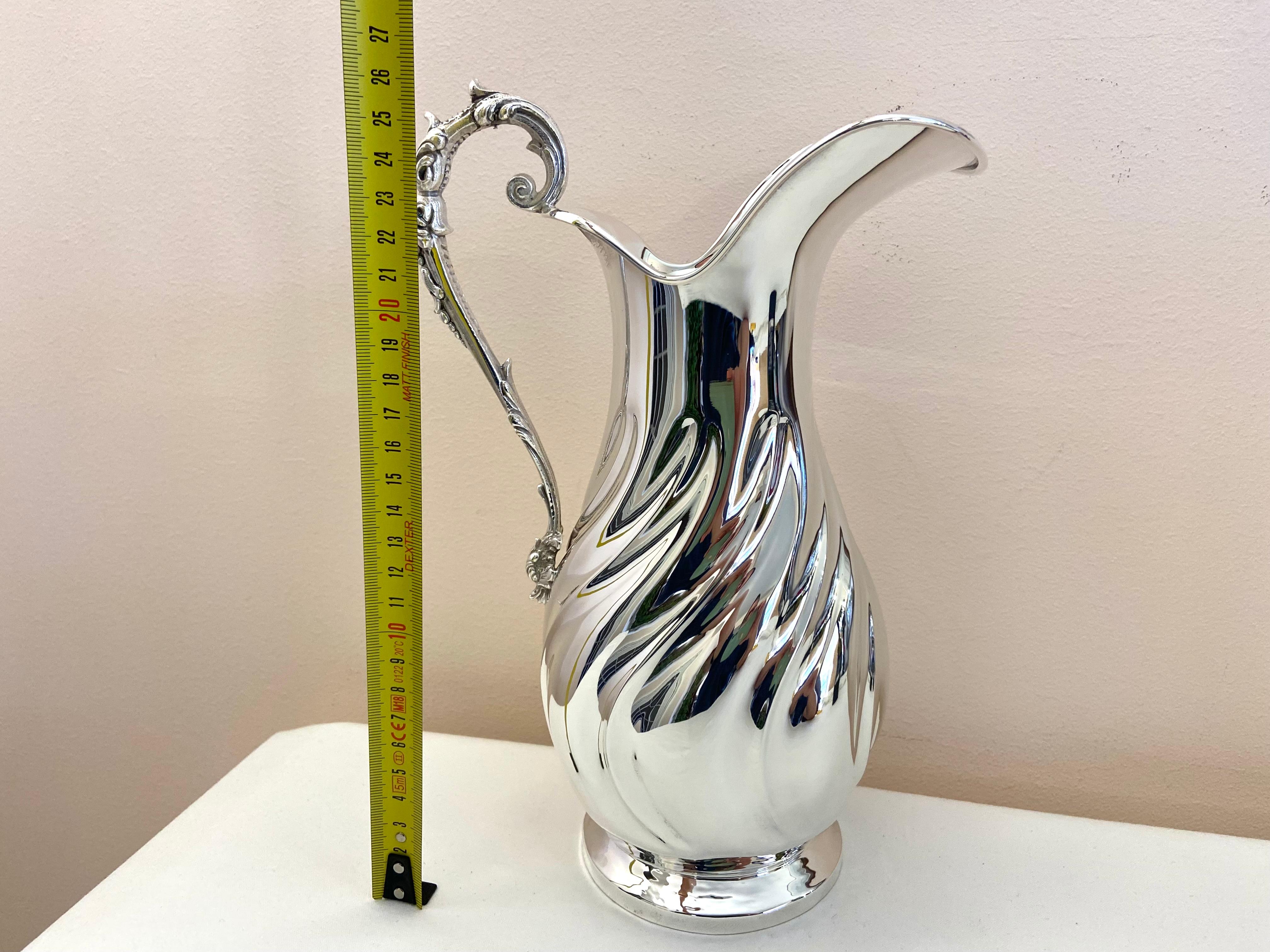 800 Silver Pitcher, new item from my jewelry.
27 cm high and 17 cm wide; It weighs 720 grams. Silver title 800 thousandths. Regularly stamped with state marks.
