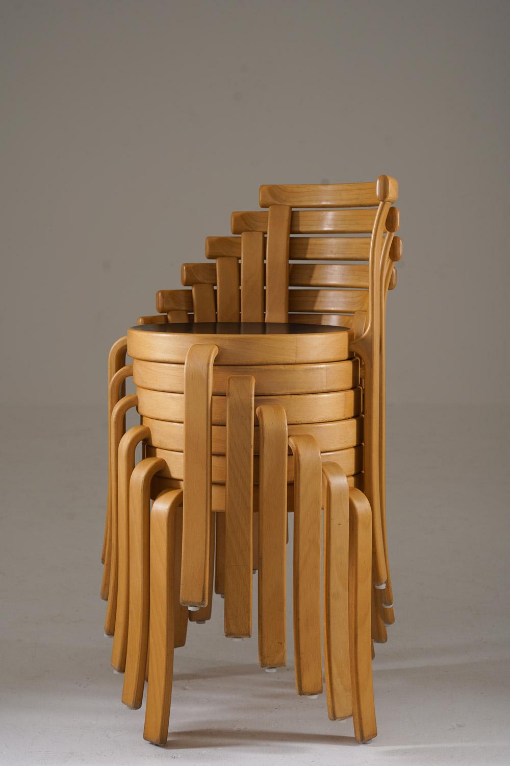 These are 8000 Series chairs by Rud Thygesen and Johnny Sørensen, crafted with a sleek and functional Scandinavian design. Made from bent beechwood, they feature gently curved backrests for support and circular black seats that contrast beautifully