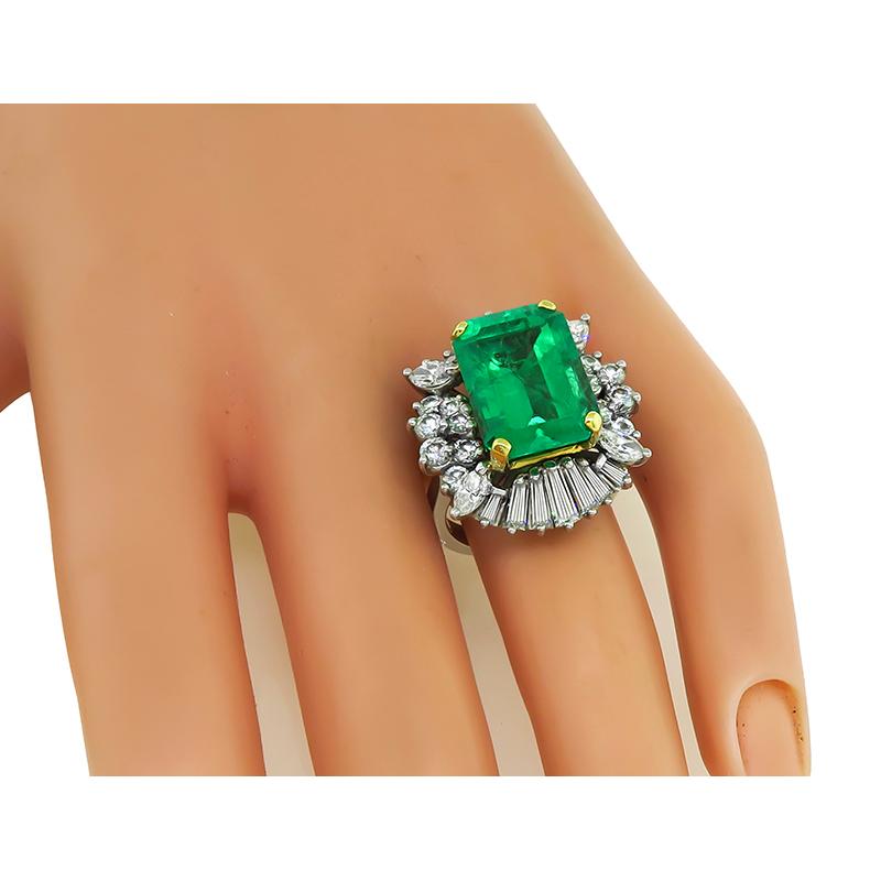 This is a stunning platinum ring. The ring is centered with a lovely emerald cut Colombian emerald that weighs approximately 8.00ct. The emerald is accentuated by sparkling baguette, marquise and round cut diamonds that weigh approximately 2.50ct.