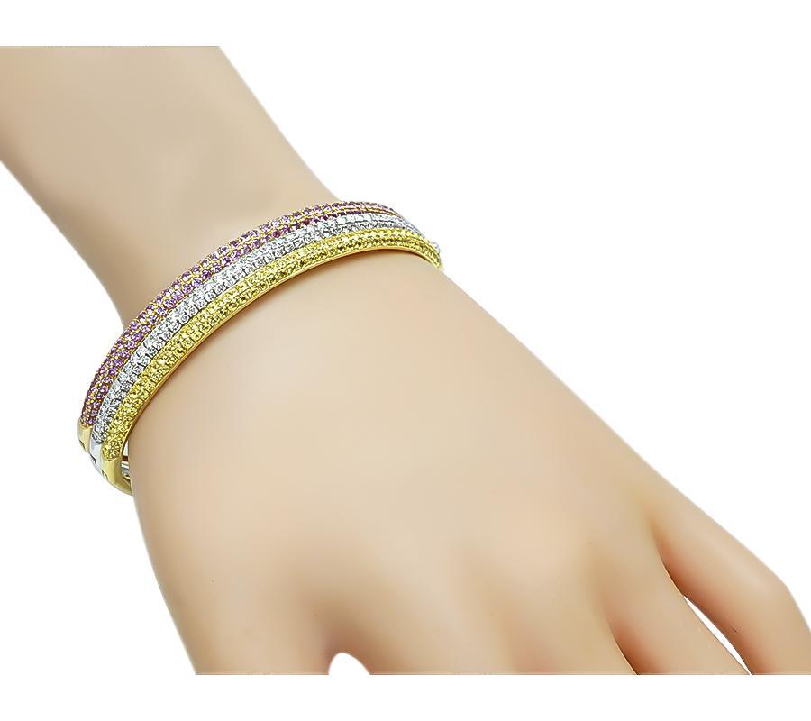 Questo è uno splendido braccialetto in oro giallo, rosa e bianco a 18 carati. Il braccialetto è incastonato con deliziosi zaffiri rosa e gialli a taglio rotondo che pesano circa 8,00ct. Gli zaffiri sono accentuati da scintillanti diamanti taglio