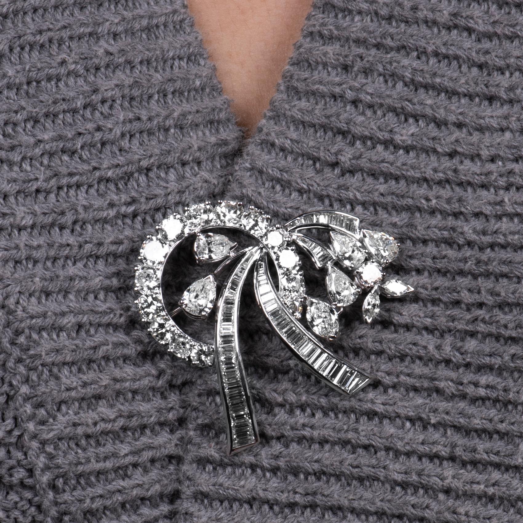 Beautiful ribbon floral design convertible brooch and pendant with approximately 8.0 carats total weight in mixed shaped diamonds set in 18K. Chain not included.
Hallmark: VAN CLIEF

Diamond quality: Approximately H-J color, VS2-SI2 average clarity.