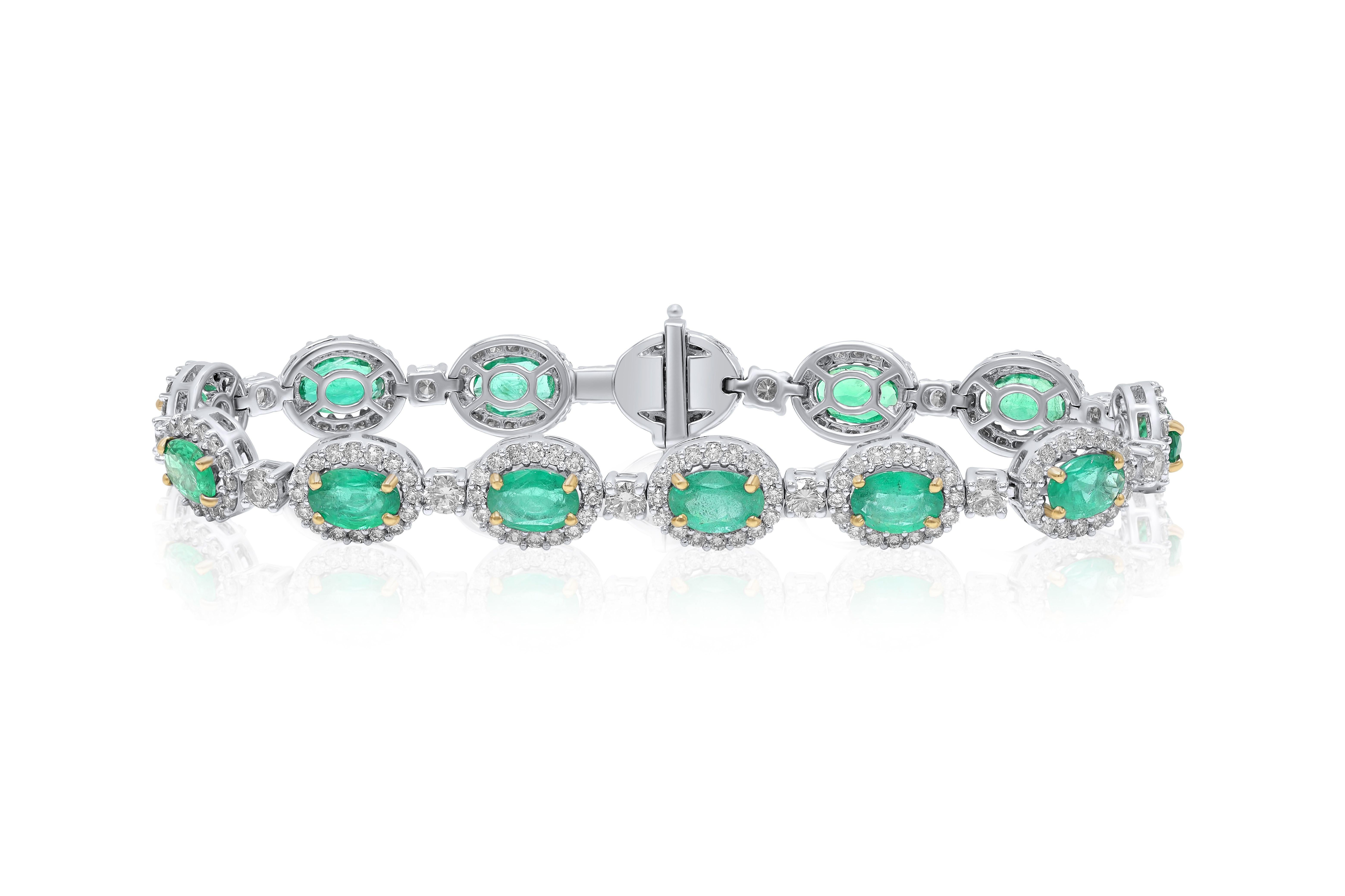 18 kt white gold diamond and emerald bracelet adorned with 8.01 cts tw of oval cut emeralds surrounded and separated by 4.12 cts tw of diamonds