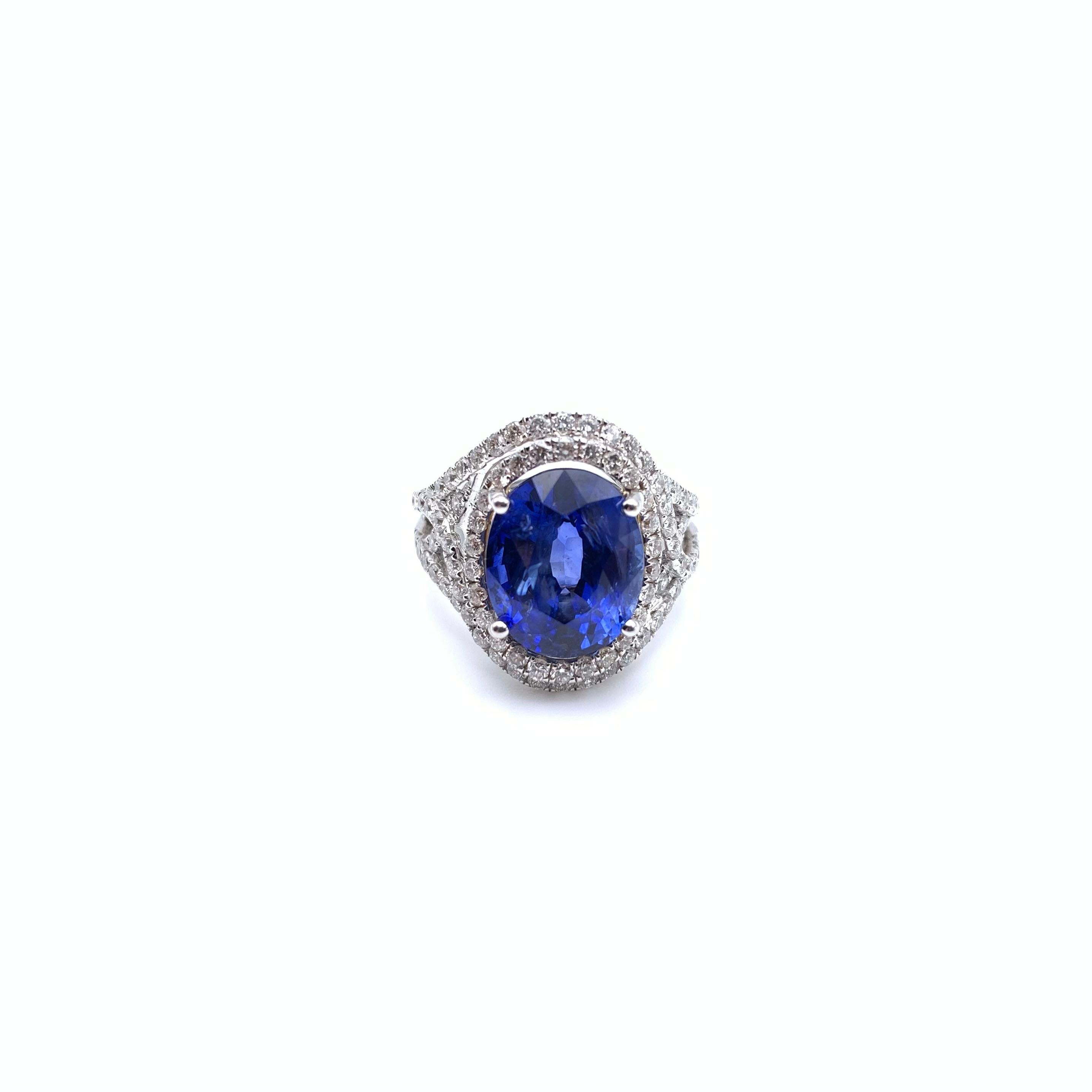 This dazzling ring is set in 18-karat white gold with a gorgeous oval-cut sapphire. The sapphire is prong set and weighs 8.01 carats. The rich blue center stone is complemented by 1.20 carats of round, full-cut diamonds. The stones grade VS in