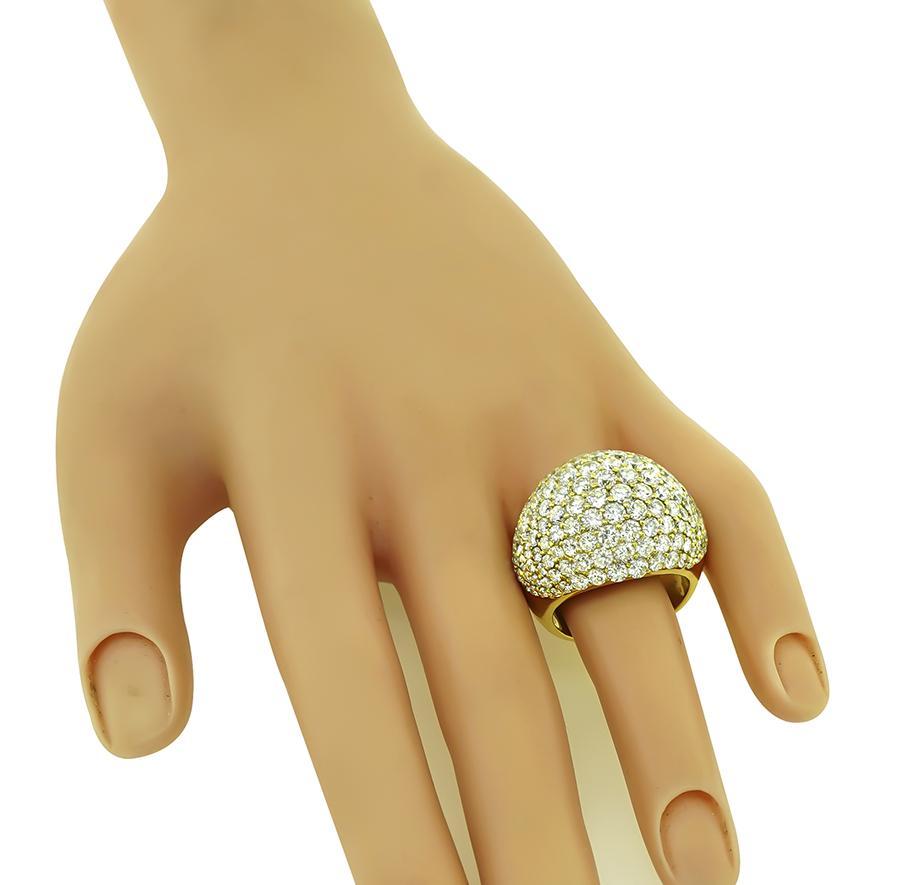 This is a magnificent 18k yellow gold ring. The ring is set with sparkling round cut diamonds that weigh approximately 8.01ct. The color of these diamonds is G with VS2 clarity. The top of the ring measures 20mm by 26mm. The ring is stamped K18 8.01