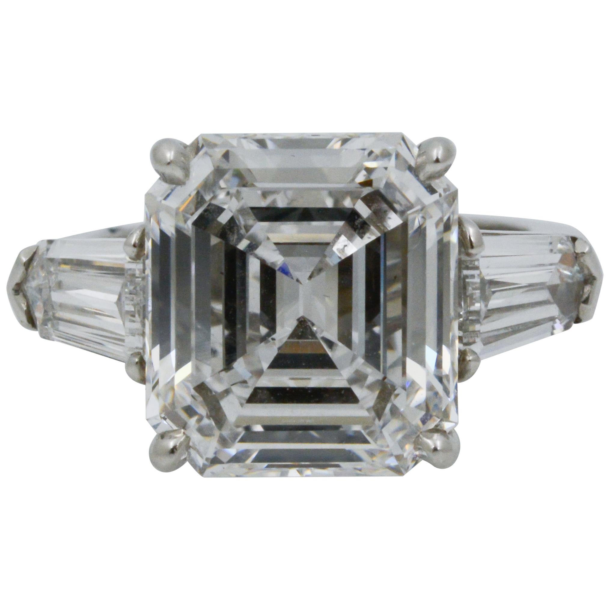 This platinum ring features an 8.02 carat emerald cut VS2 GIA certified diamond, flanked by two bullet shaped diamonds, weighing 1.33ctw D SI1/E flawless. 
