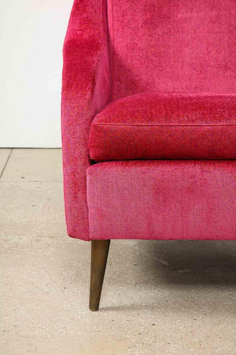 Wood, fabric, brass. Sculptural lounge chair, fully upholstered in fuchsia-colored velvet, with deep seat and oxidized brass-cone legs. Produced by Cassina. This example is particularly desirable with the brass-cone legs. Published: Il Mobile