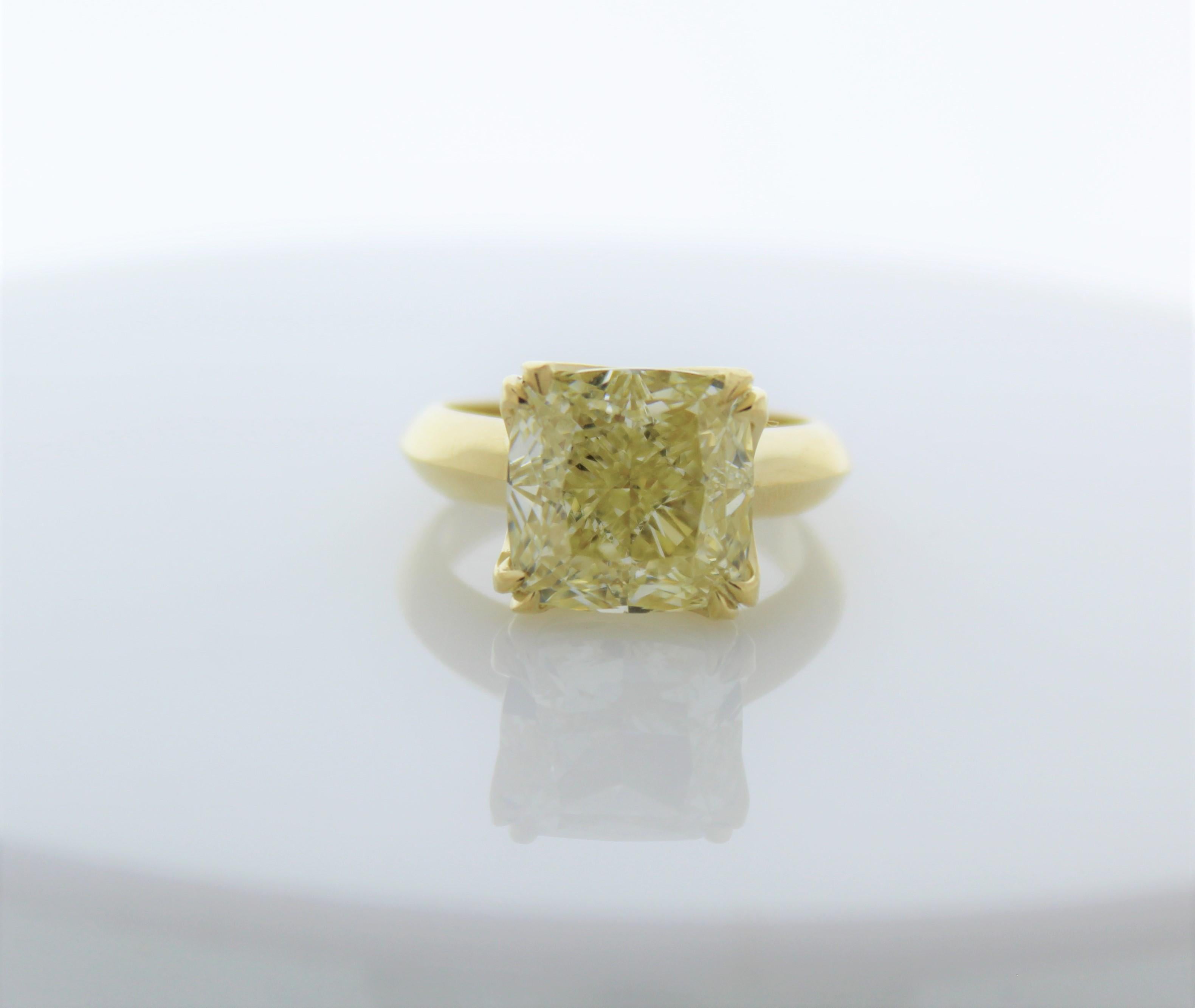 Before we get into the details, take a moment to soak in the lavishness and exceptional beauty of this ring. It’s made to turn heads and endure for a lifetime. A richly saturated 8.02CTW GIA certified natural cushion-cut, lemon-yellow diamond adorn