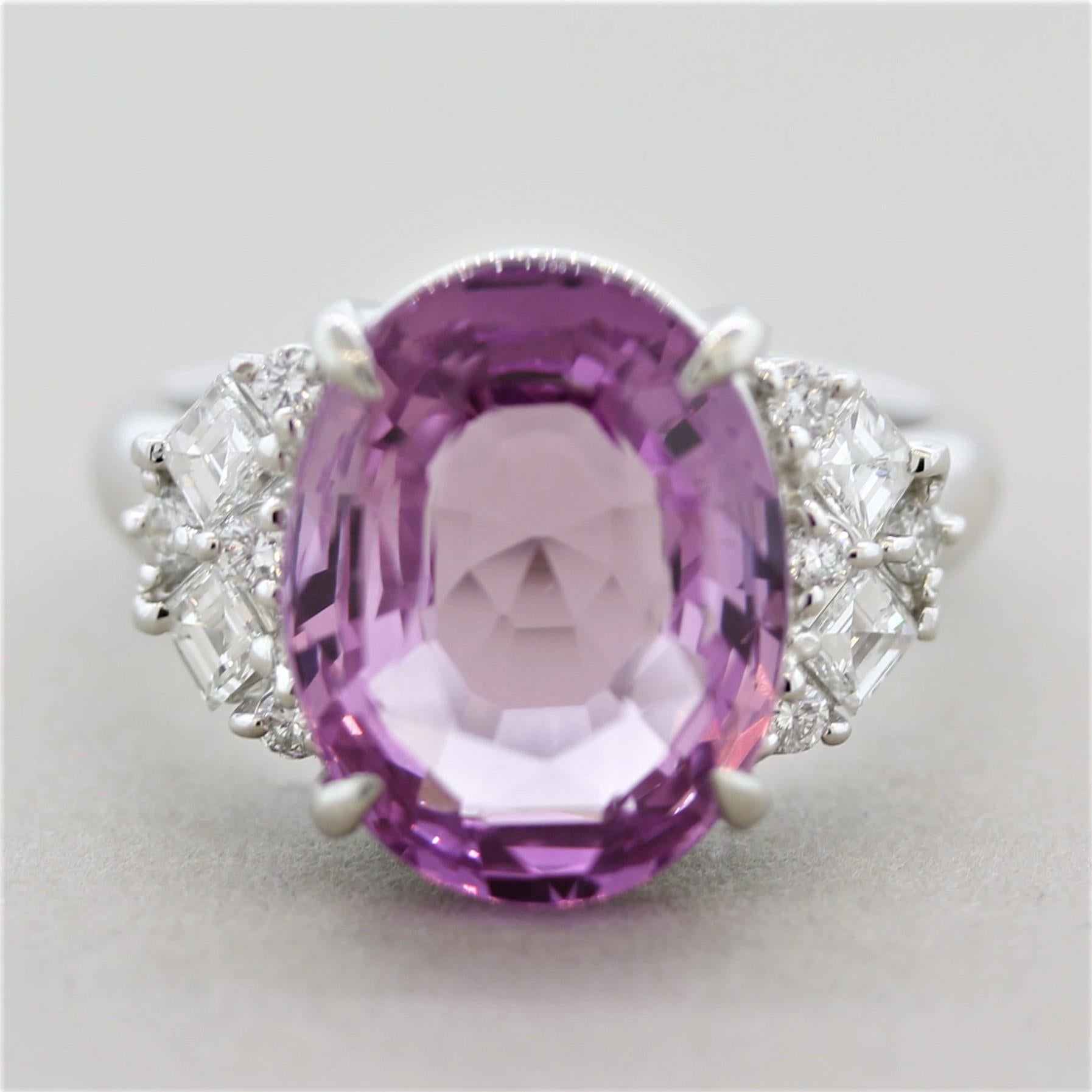 A large and impressive 8.04 carat purple-pink sapphire certified as natural by the GIA! It has a beautiful rich purple-pink color and is free from any eye-visible inclusions allowing the stones natural brilliance to showcase. It is accented by 0.64