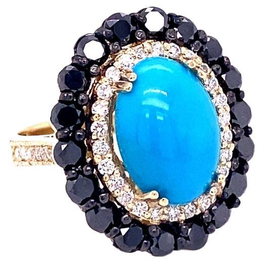 8.04 Carat Turquoise Black Diamond Yellow Gold Cocktail Ring

This ring has a 4.90 Carat Oval Cut Turquoise and is surrounded by 18 Round Cut Black Diamonds that weigh 2.57 Carats.  The Black Diamonds are natural diamonds that are color treated to