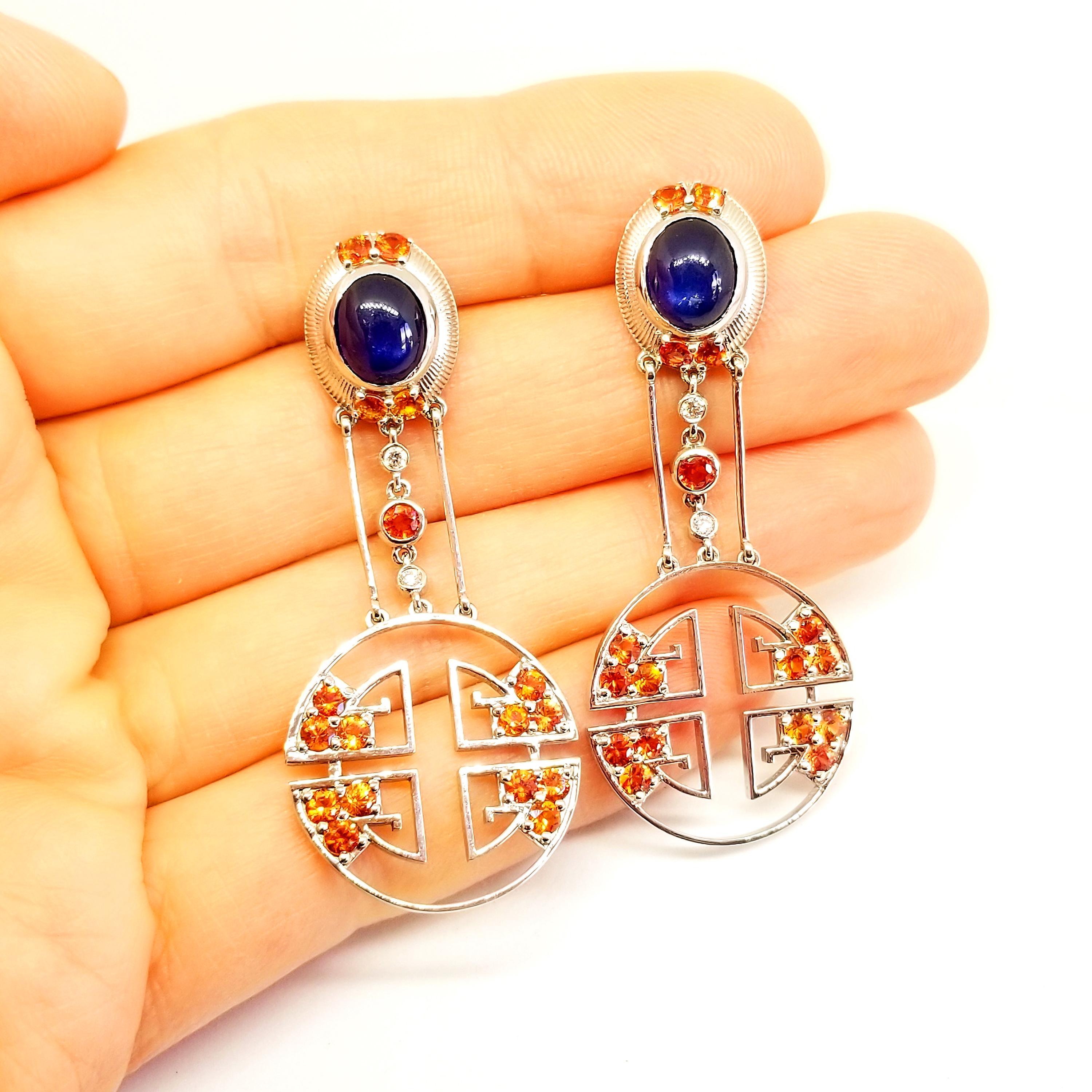 These Custom Designed and Crafted Earrings are One of a Kind and feature the Lu Riches, or Good Fortune of Oriental Deco Style. The Earrings boast a matched pair of Cabochon, Rich Medium Blue hue, Sapphire ovals at the ear. The two Gem Quality