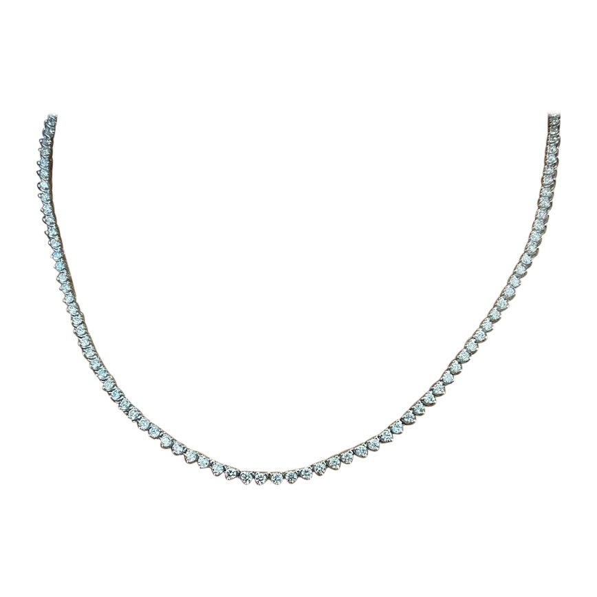 This classic diamond tennis necklace features 130 diamonds weighing 7.26 ct set in 14k white gold. The diamonds are graded F-G in color and VS2-SI1 in clarity. The diamonds are of exceptional quality and are set in a classic tennis style. The