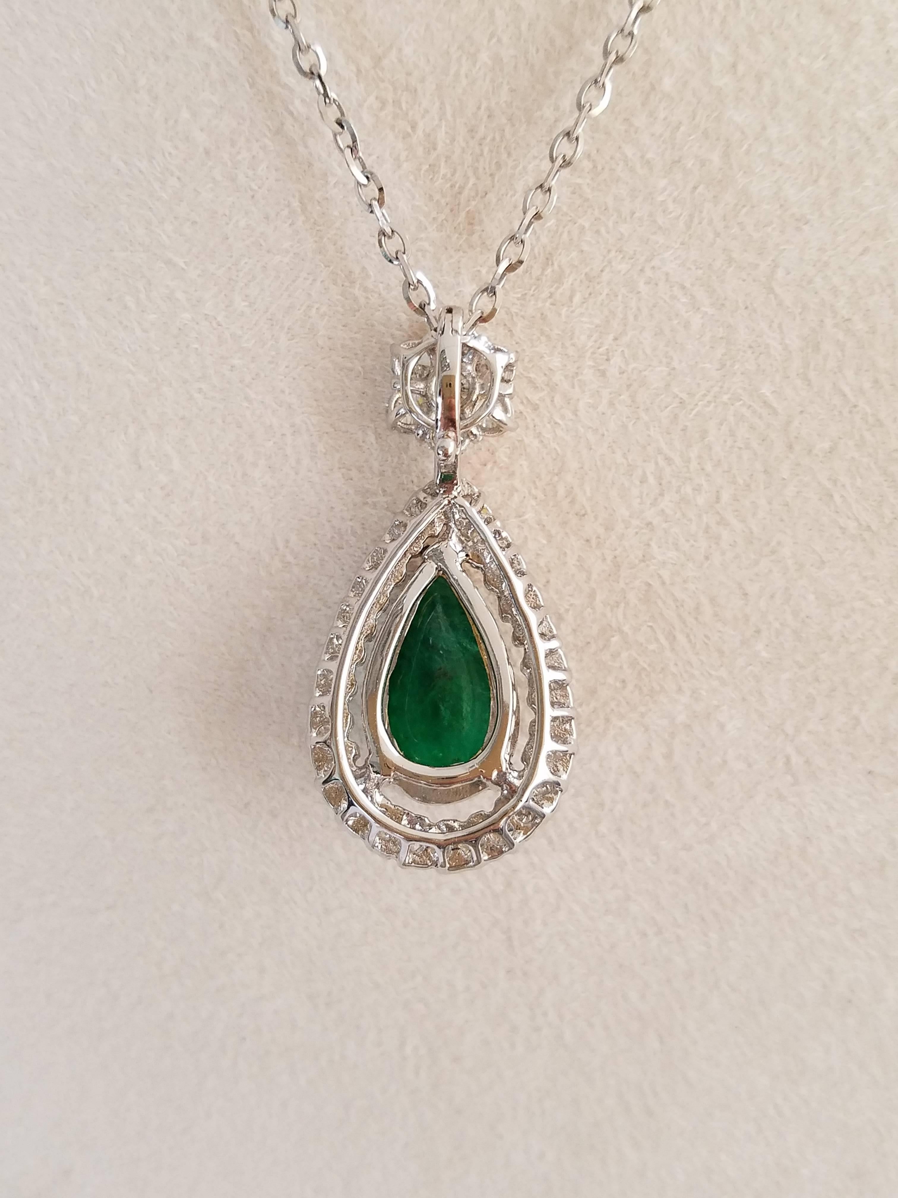 An elegant and simple pendant, with a pear shaped Zambian Emerald cabochon centre stone surrounded by brilliant cut white Diamonds, all set in 18K white gold. 

Stone Details: 
Stone: Zambian Emerald
Carat Weight: 8.06 Carats

Diamond Details: