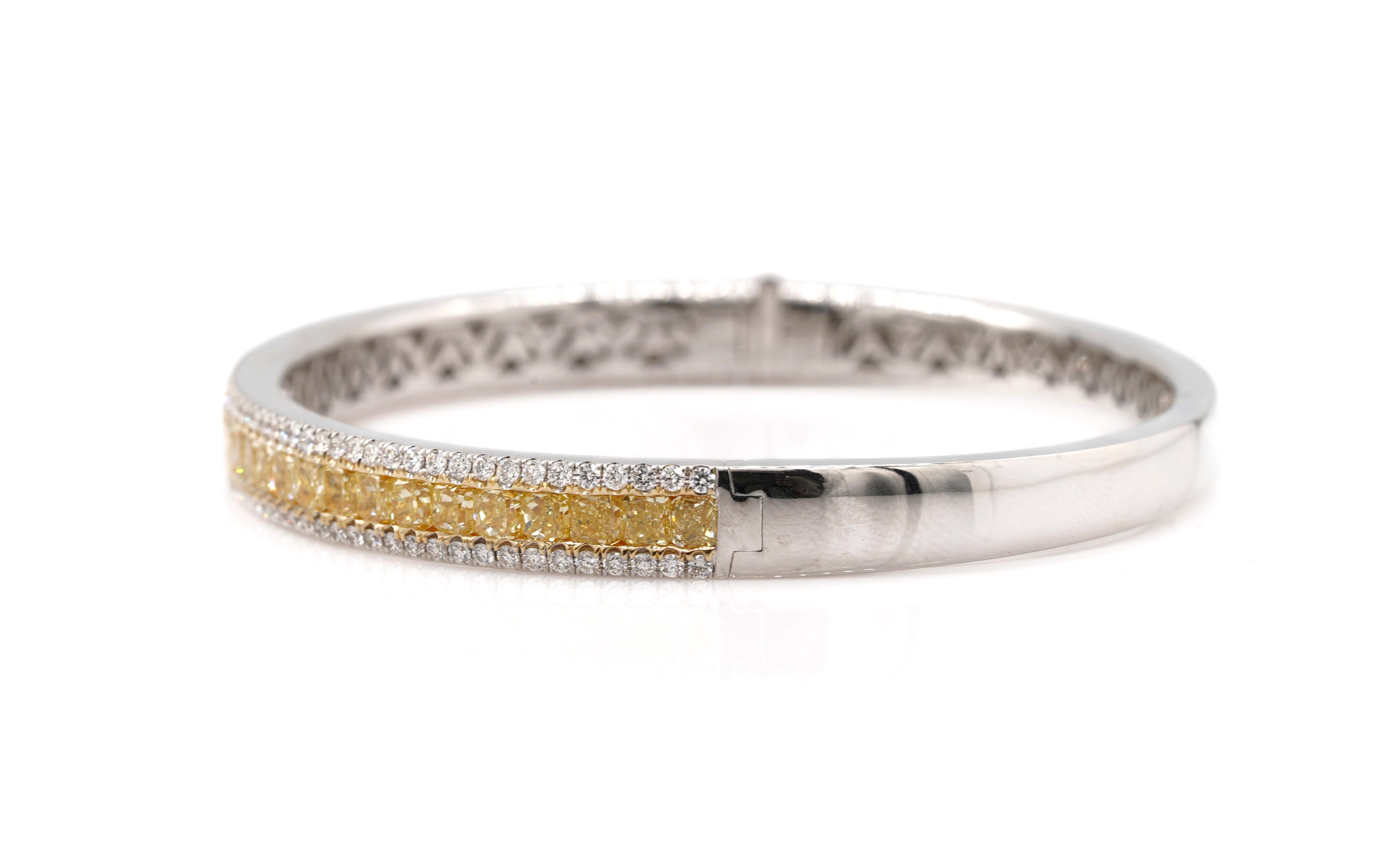 this exquisite 8.08-carat bangle diamond bracelet is a true masterpiece. Handcrafted with meticulous attention to detail, it showcases 34 radiant-cut fancy yellow diamonds, totaling 6.74 carats.
The bracelet is adorned with 128 round brilliant-cut