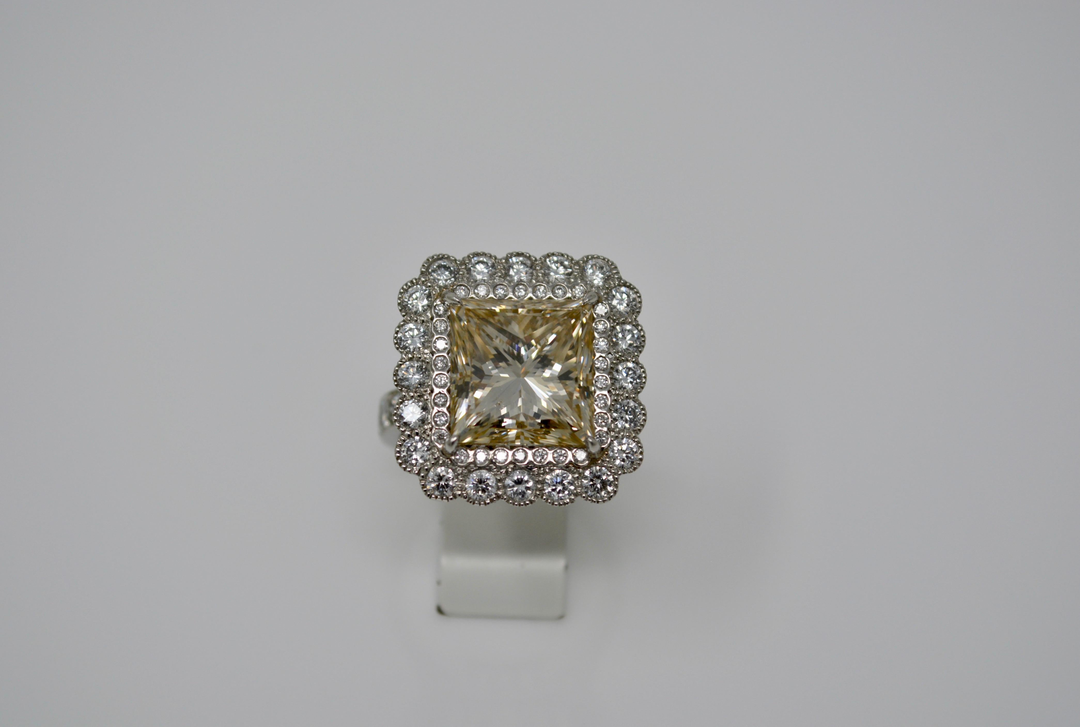 This exquisite ring has a beautiful light brown princess cut diamond weighing 8.09 carat with VS clarity which is encircled by two rows of small white diamonds weighings 2 carat with VS clarity. This ring is hand crafted in platinum in NEW YORK .The
