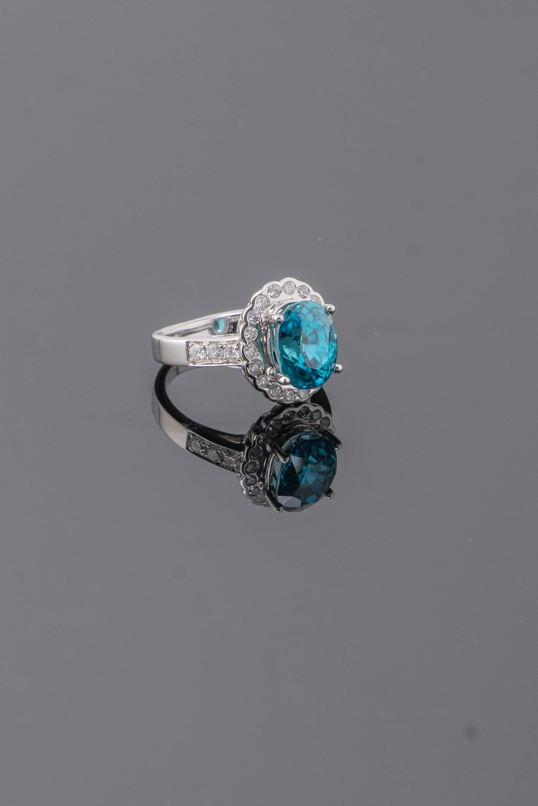 This eye clean, lustrous Blue Zircon ring is elegant and stately! Rows of glittering diamonds stretch up the shoulders of the ring, leading the eye to the center stone. Currently sized at US 6, can be altered. 
We accept returns. 
Free shipping