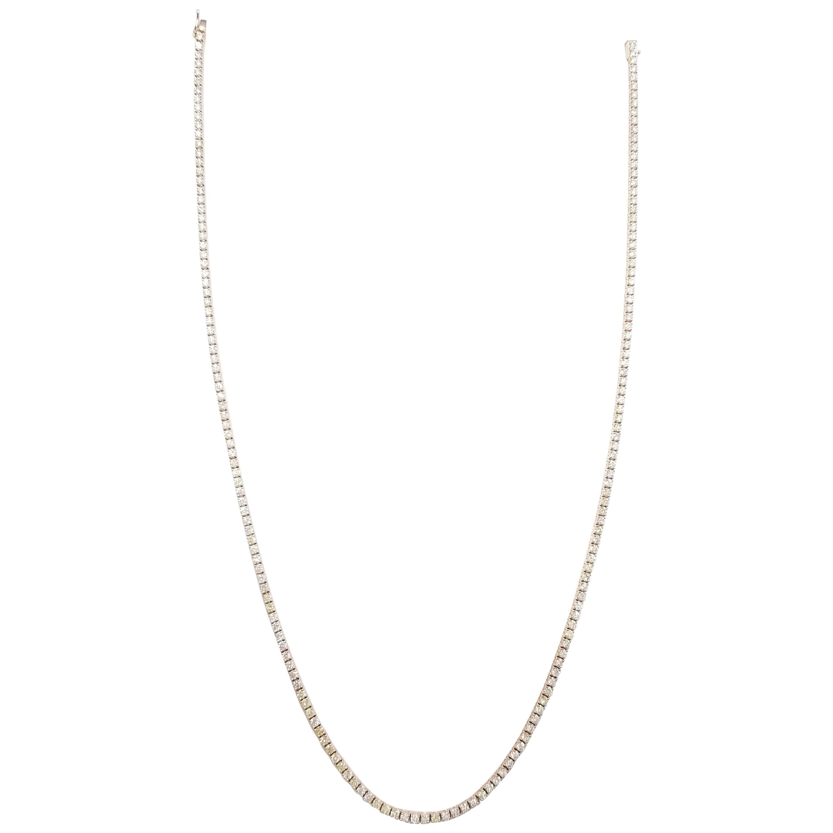 Elegantly simple 14 Karat Yellow Gold Round Brilliant Cut Diamond Tennis Necklace set on 4 prong setting. The total diamond weight is 8.09 carats. The closure is an insert clasp with safety clasp. Length is 18 inches. Average Color H, Clarity SI.