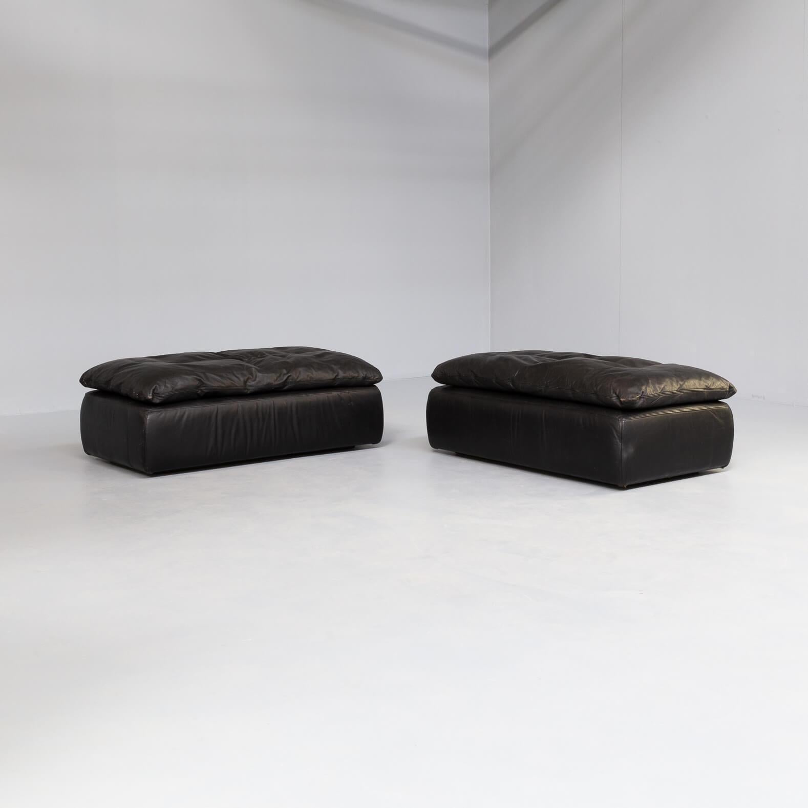 Beautiful set leather poufs, also to be positioned as small, two seat sofas. The freestanding poufs are great in design and high in comfort. Black leather original 1980s.