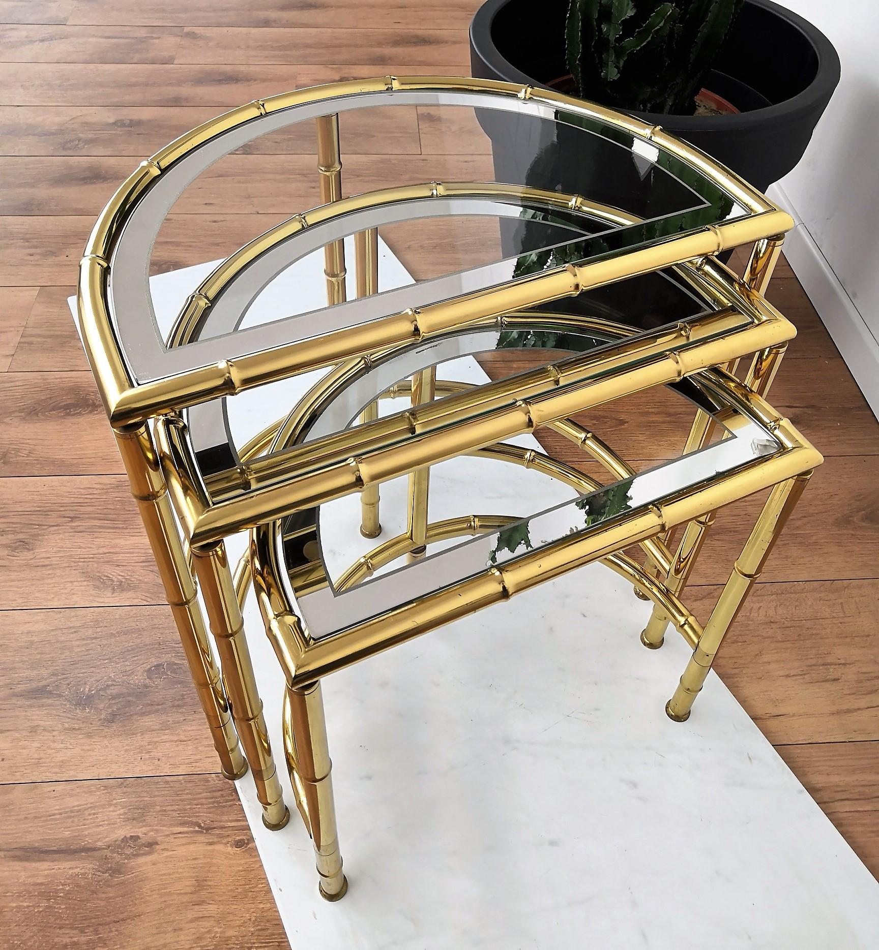 Vintage faux bamboo brass set of three round nesting tables, or stacking tables, for Classic and elegant coffee table or side tables with clear glass and mirror reserve top, manufactured in the 1980s. The tables can be used separately as well as a