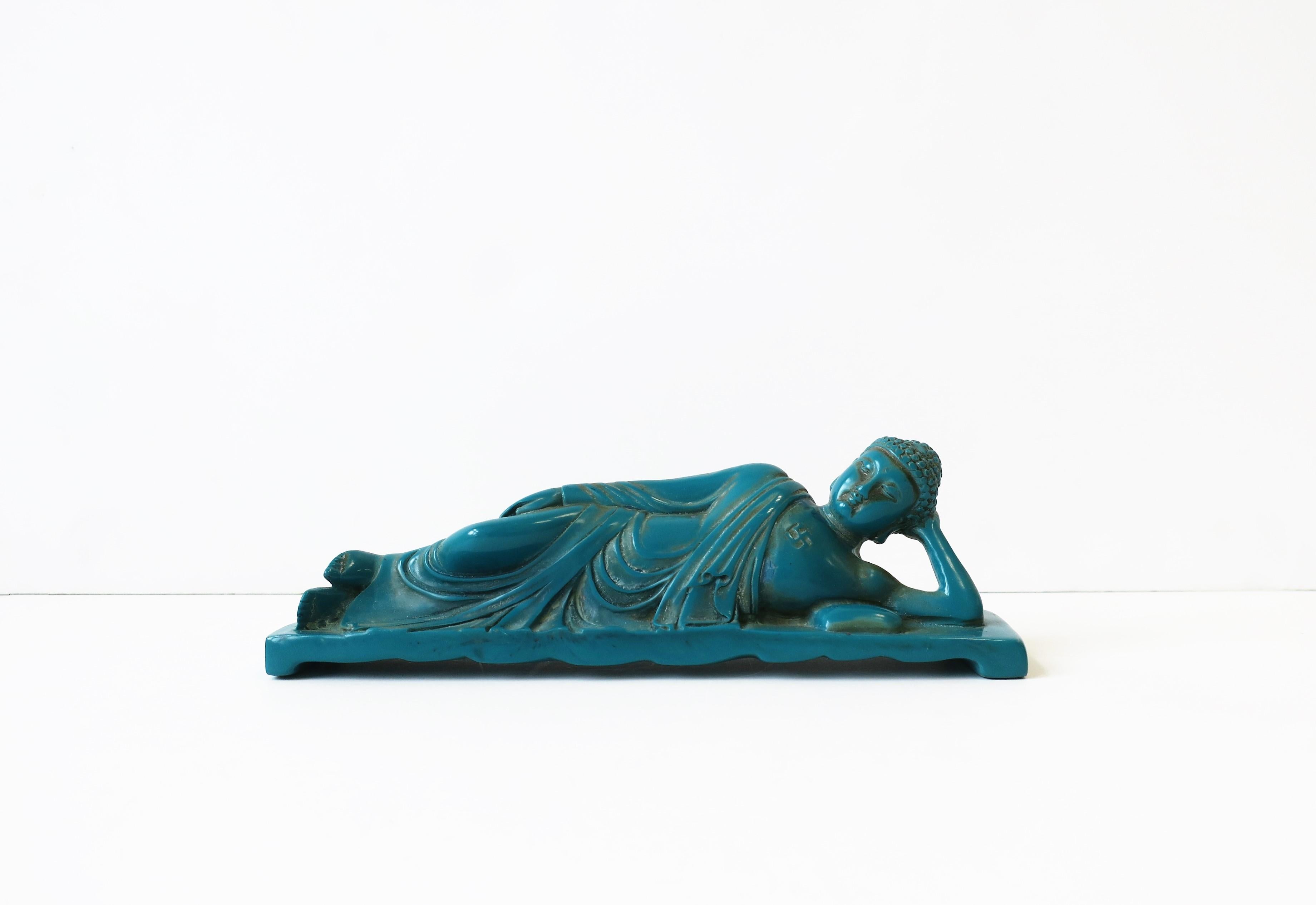 A vintage turquoise blue resin Buddha sculpture or decorative object, late-20th century, circa 1980s-1990s. Buddha is resting or 'lounging' on bed with pillow. Piece measures: 2.75