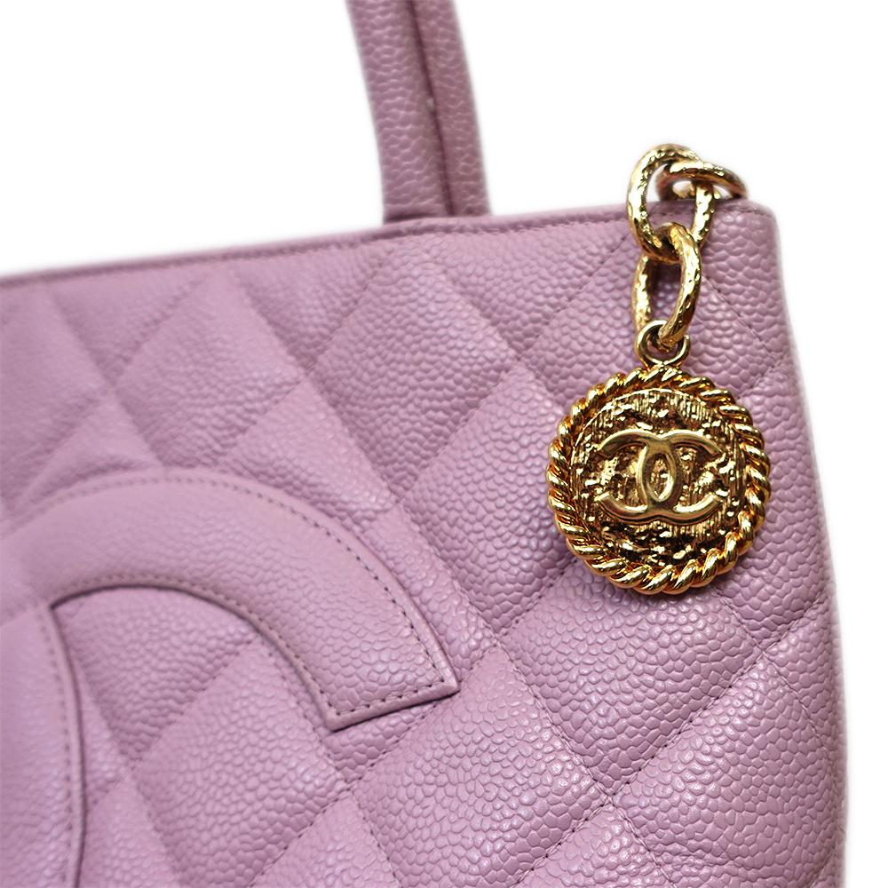 Chanel Lilac Caviar Leather Medallion Tote Bag

Exterior Material
Lilac quilted leather exterior with single patch pocket at back, gold hardware, dual top handles and zip closure at top.

Interior Material
Tonal leather lining with one main