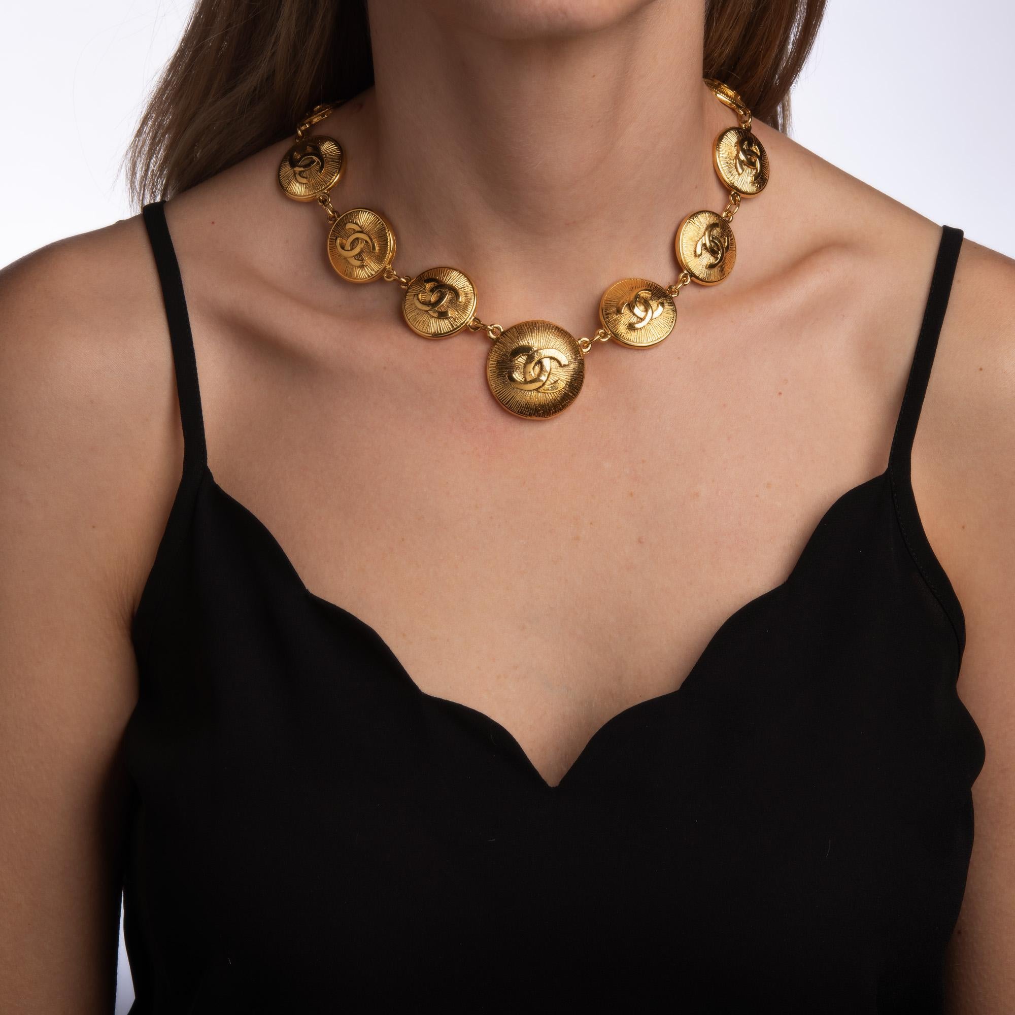 Vintage 80s Chanel medallion necklace crafted in yellow gold-tone (circa early 1980s). 

The necklace features 'CC' logo medallions that graduate in size from 22mm (0.86 inches) to 32mm (1.25 inches). Measuring 17 inches in length the necklace is