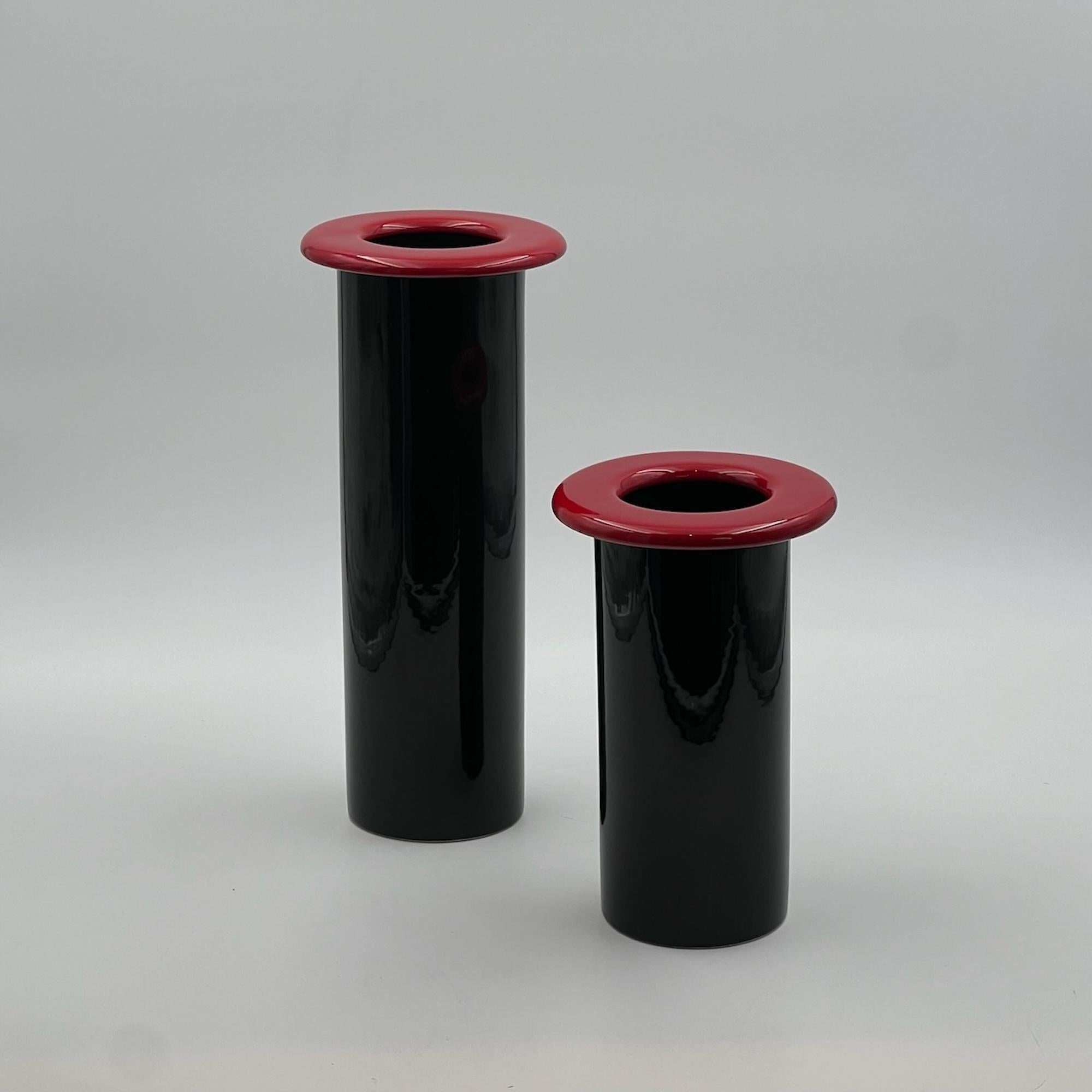 Transport yourself back to the vibrant era of the 1980s with this exquisite pair of 80s ceramic vases crafted in Italy. Embodying the essence of 80s design, these vases feature a slender and elegant silhouette, accentuated by a deep black hue that