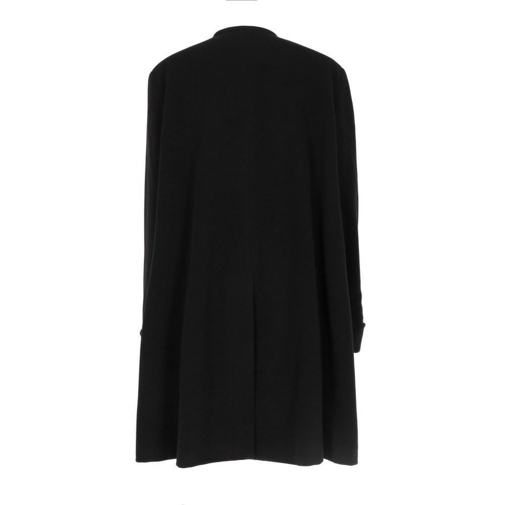 Emporio Armani black wool coat. Crewneck, front closure with buttons and lace. Two welt pockets, long sleeves and decorative gathered cuffs.

Size: 42 IT

Flat measurements
Height: 103 cm
Bust: 58 cm
Shoulders: 48 cm
Sleeves: 68 cm

Product code: