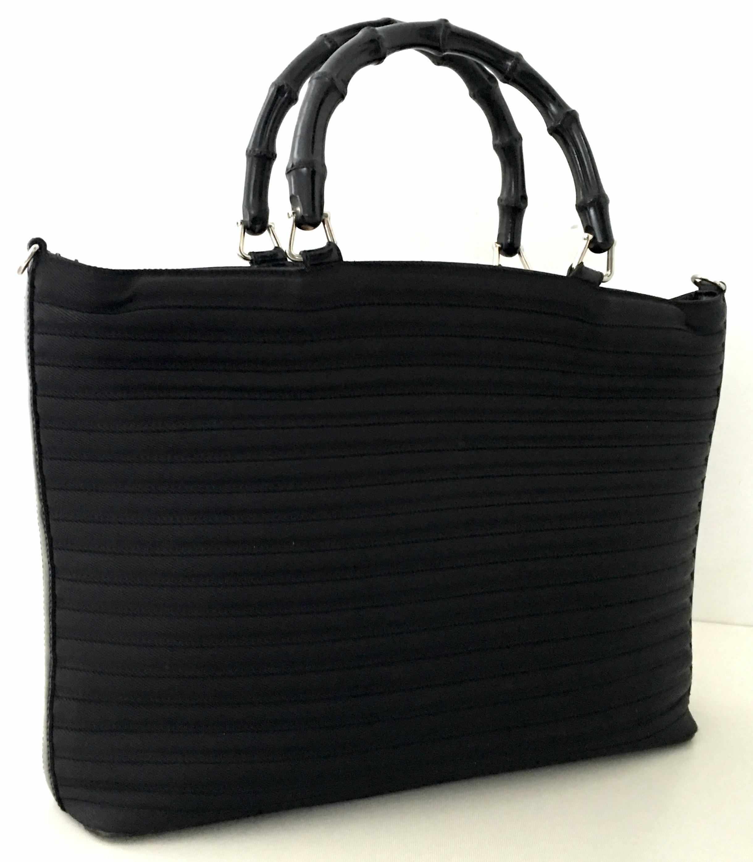 1980'S Gucci black pleated nylon, leather trim and faux bamboo wood handle two-way large tote hand bag. Includes detachable leather strap. Features silver chrome hardware, wood faux bamboo toggle zipper close,  fully lined Gucci monogram lined