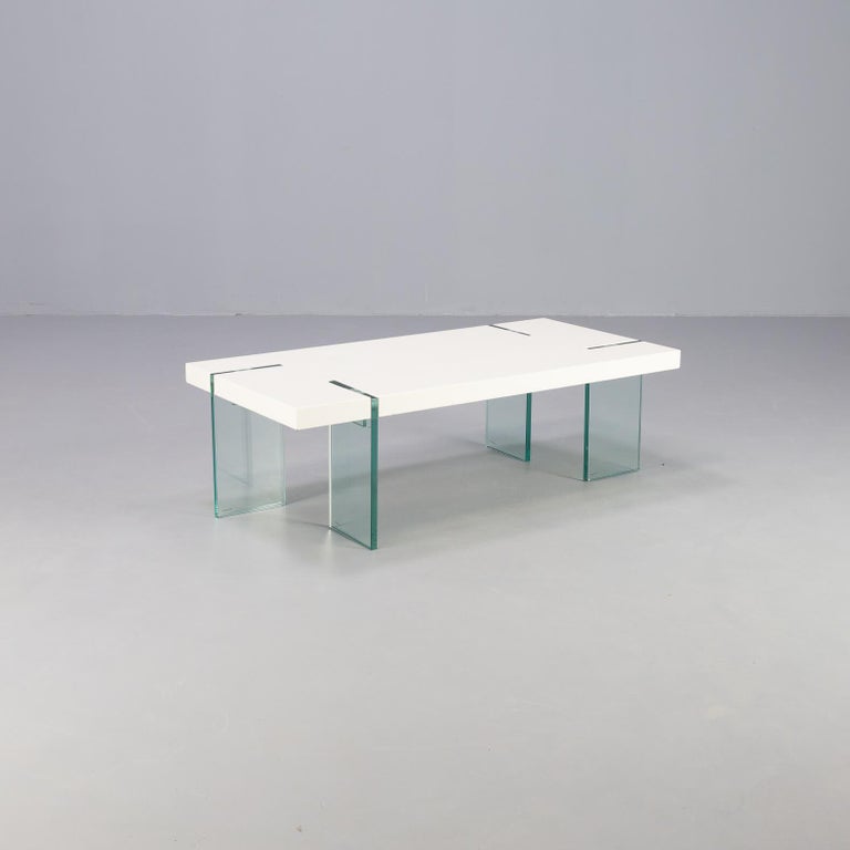 Italian design coffee table on glass feet and mdf white laminated table top.
