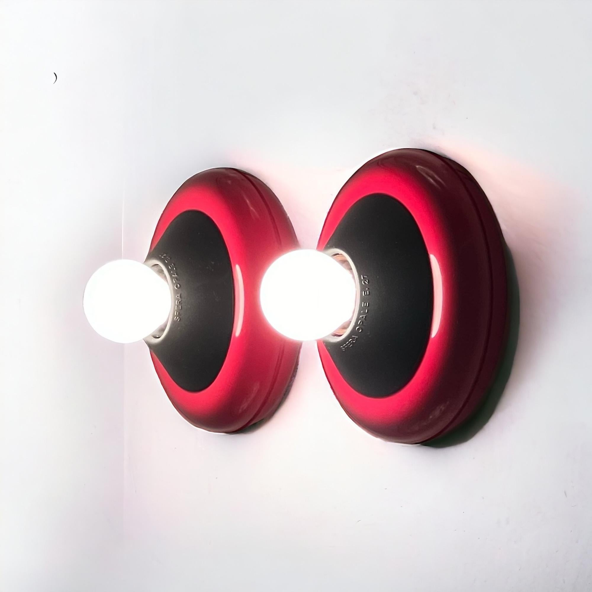 Step into the vibrant world of 1980s design with Luci Milano’s iconic ‘Flopi’ flush mount lamps. Designed by Tresoldi & Salvati, these lamps boast a sleek and minimalistic shape infused with the unmistakable energy of the era. With a striking red