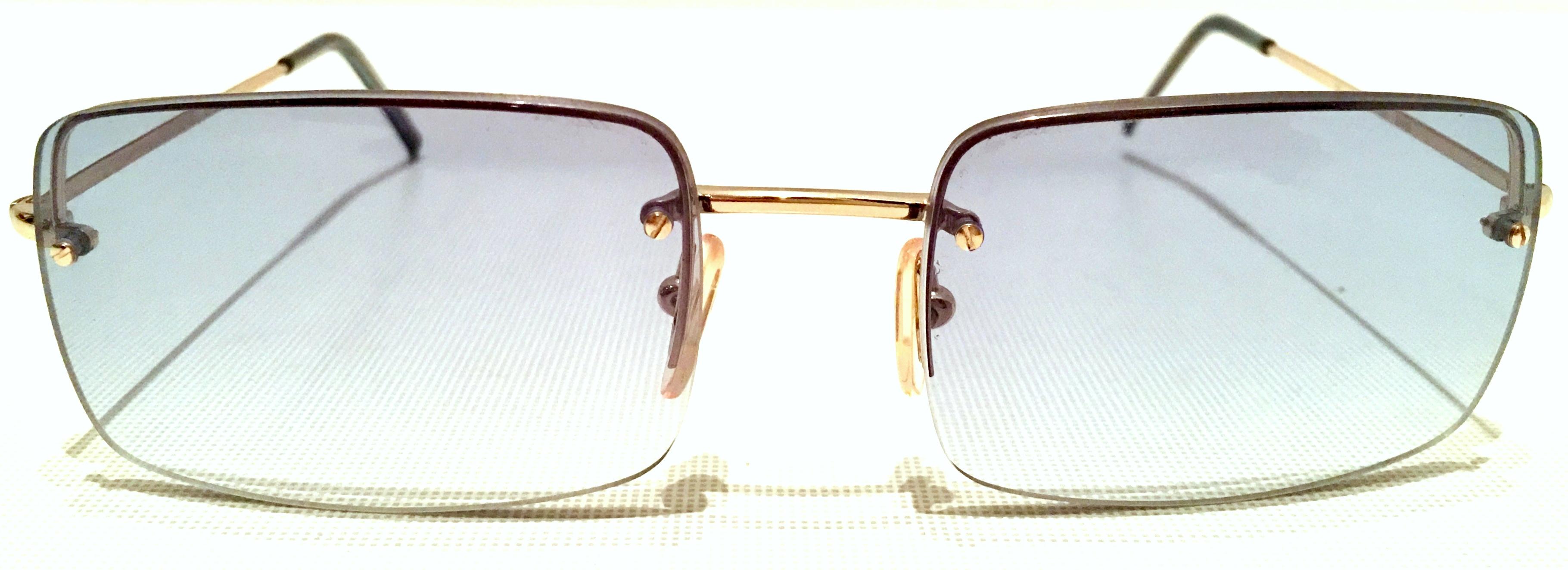 1980'S Italian 22K Gold Plate & Blue square rimless sunglasses By, Gucci. Includes authentic Gucci hard protective carrying case. Features the GUCCI logo on each exterior exterior arm. Signed on the interior, Made In Italy-Gucci.