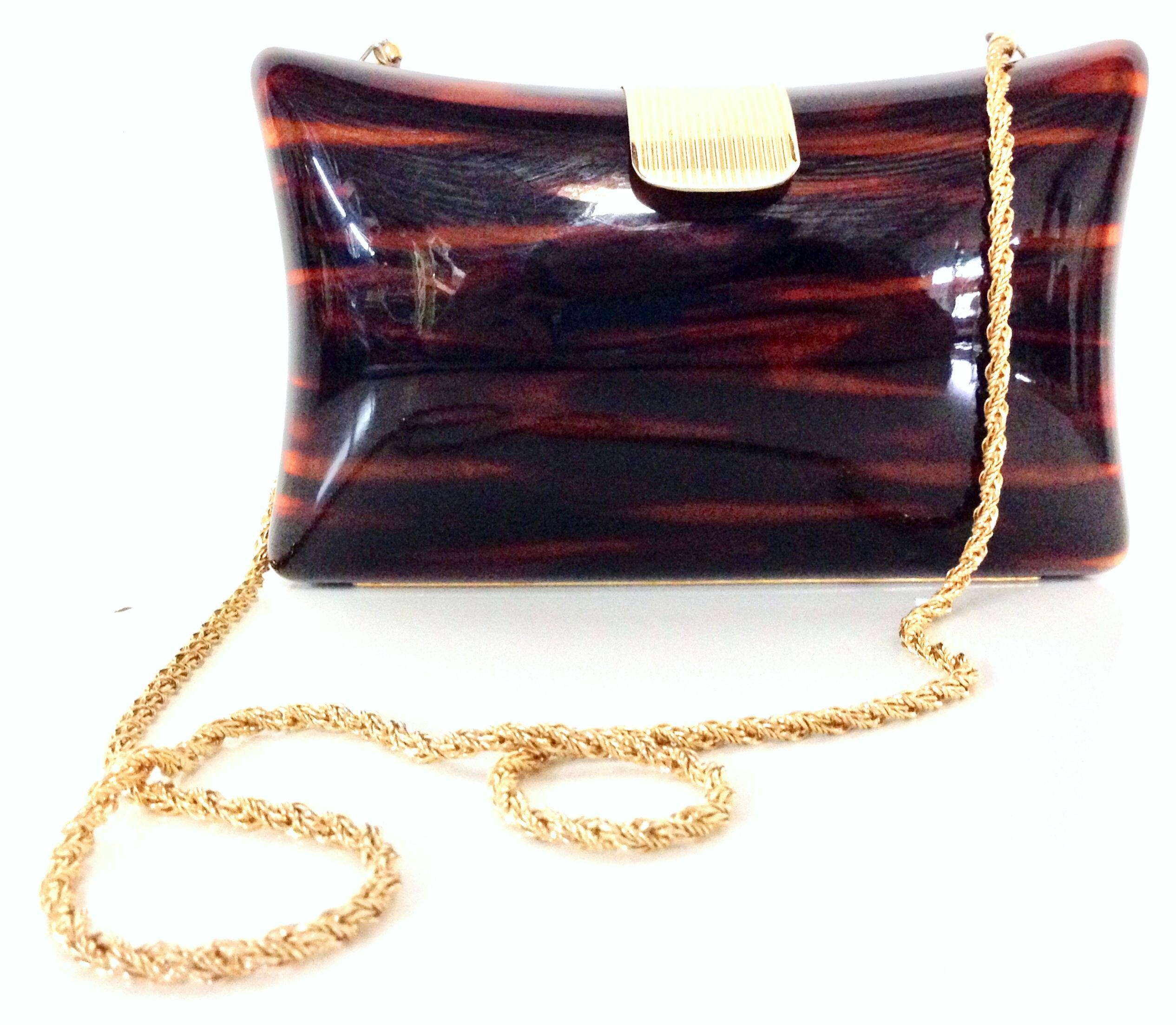 1980'S Italian Lucite faux-tortoise & gilt gold brass hard case hand bag By, Jordan Marsh. This polished Lucite faux tortoise clutch or shoulder hand bag feature, gilt gold brass fold over clasp, and chain link shoulder strap with a 17.5