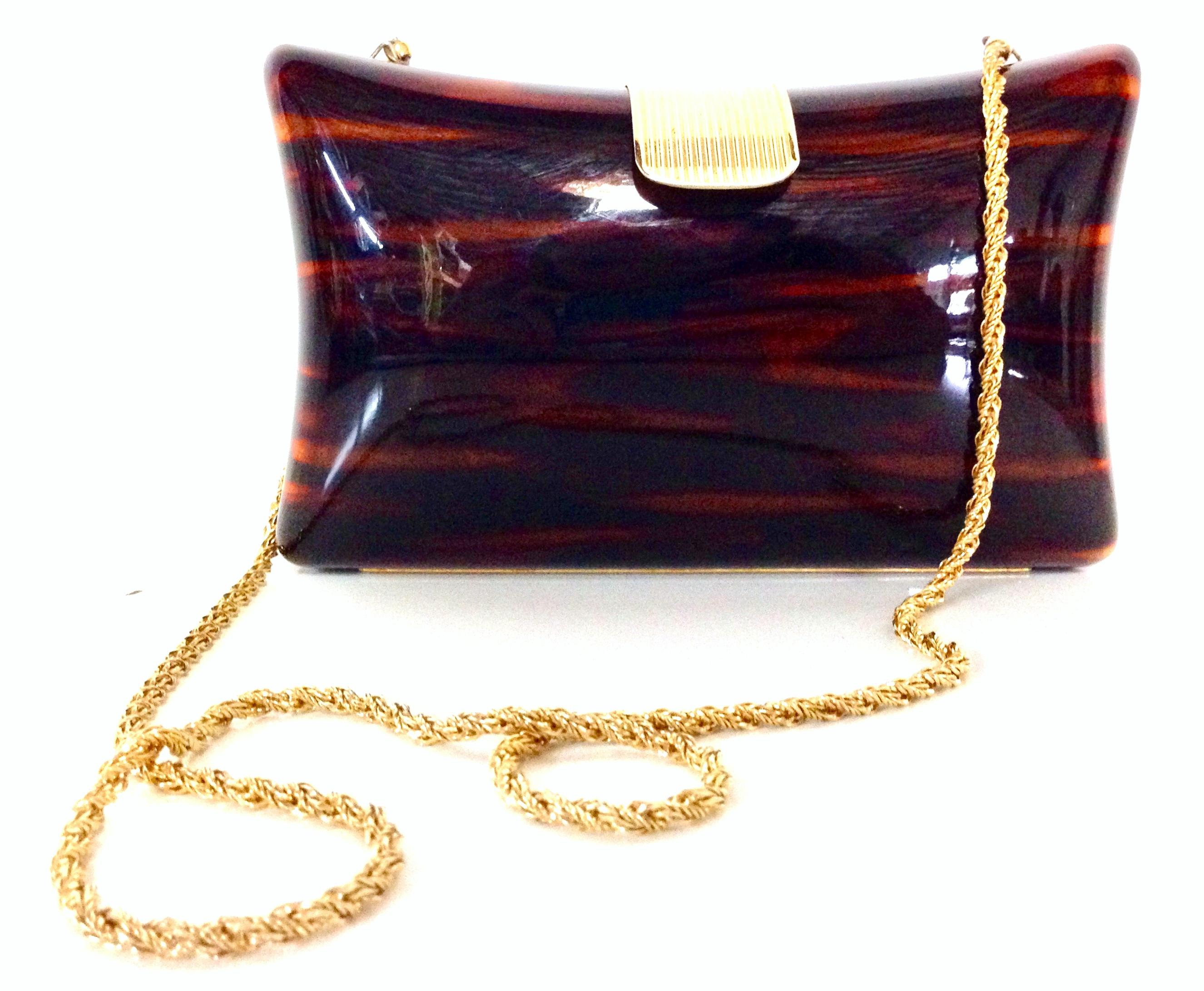 1980'S Italian Lucite faux-tortoise & gilt gold brass hard case hand bag By, Jordan Marsh. This polished Lucite faux tortoise clutch or shoulder hand bag feature, gilt gold brass fold over clasp, and chain link shoulder strap with a 17.5