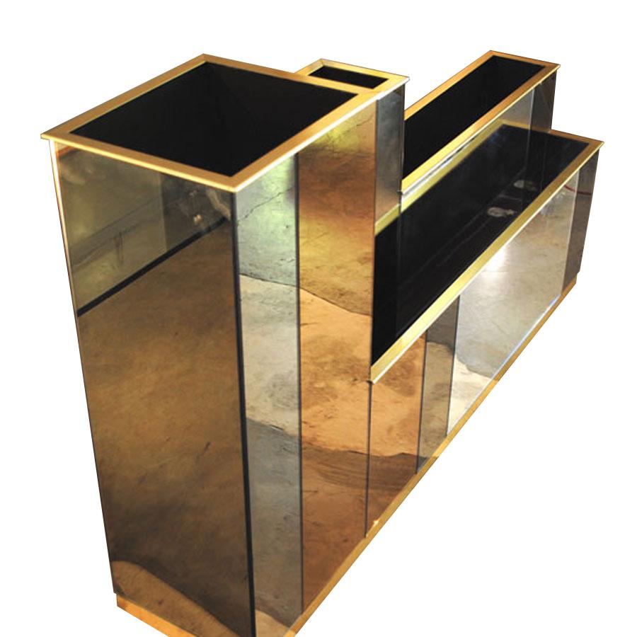 A planter front the Italian midcentury 1980s. Wooden structure completely covered with colored mirrors of different colors, gold metal finishes.