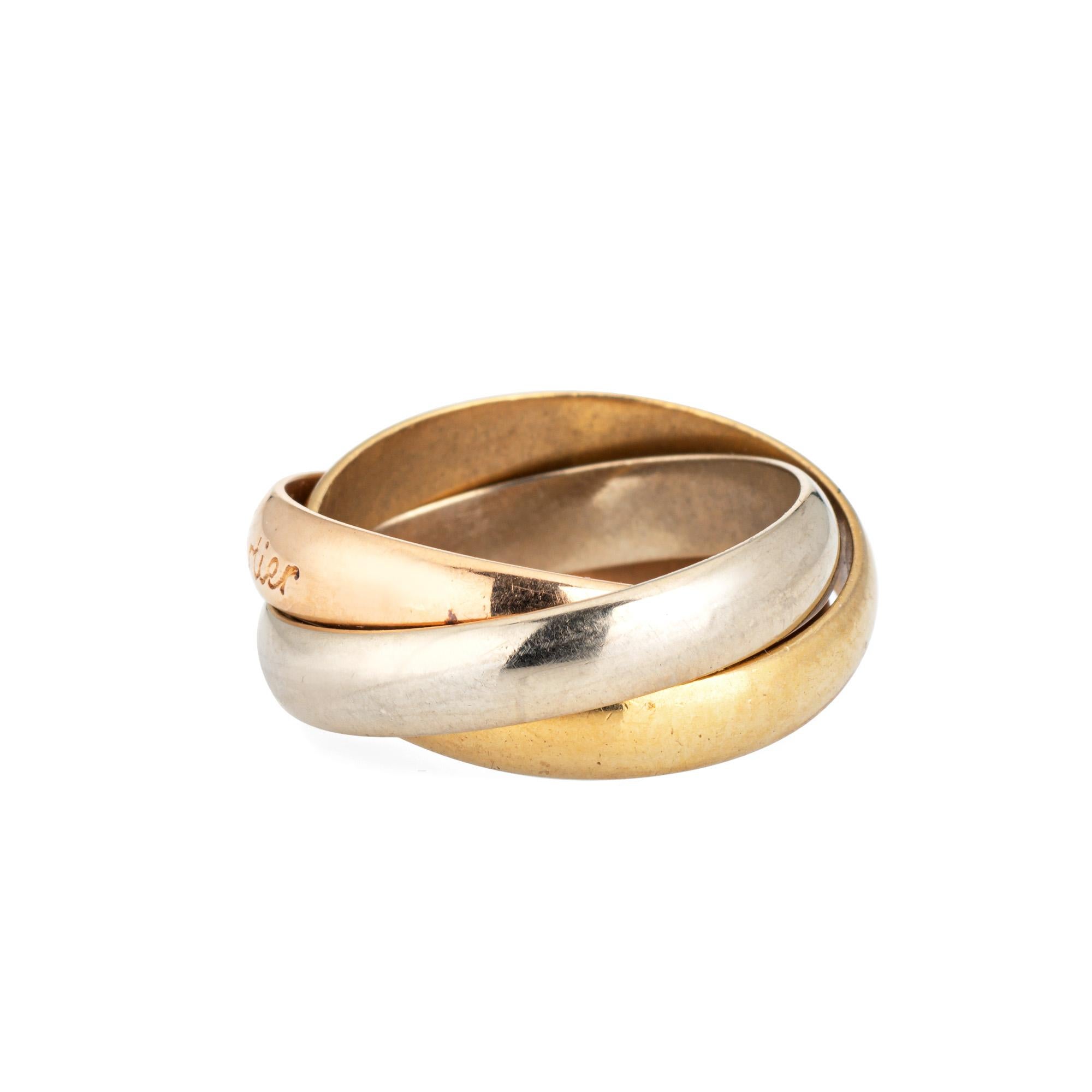Vintage les Must de Cartier Trinity ring crafted in 18k yellow, white & rose gold (circa 1980s).  

The Cartier ring features 3 bands of 18k rose, yellow & white gold. Each band measures 3.5mm wide. The ring is great worn alone or layered with your