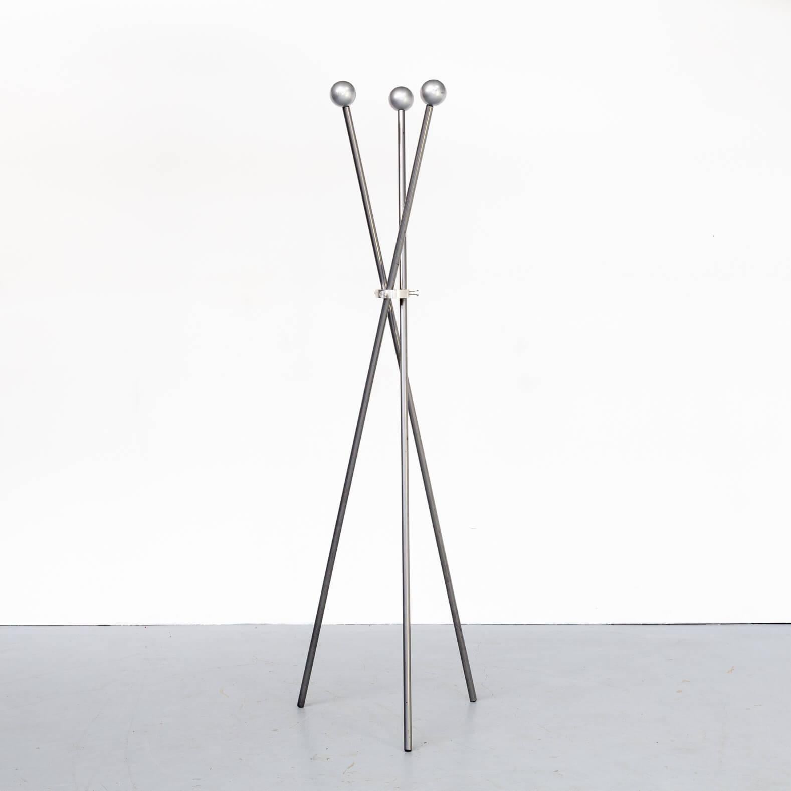 Freestanding minimalistic design coat rack. The three single sticks of the coat rack are mounted together in the middle part of the rack in a cast aluminium ring with three turning bolds. Very esthetic design.