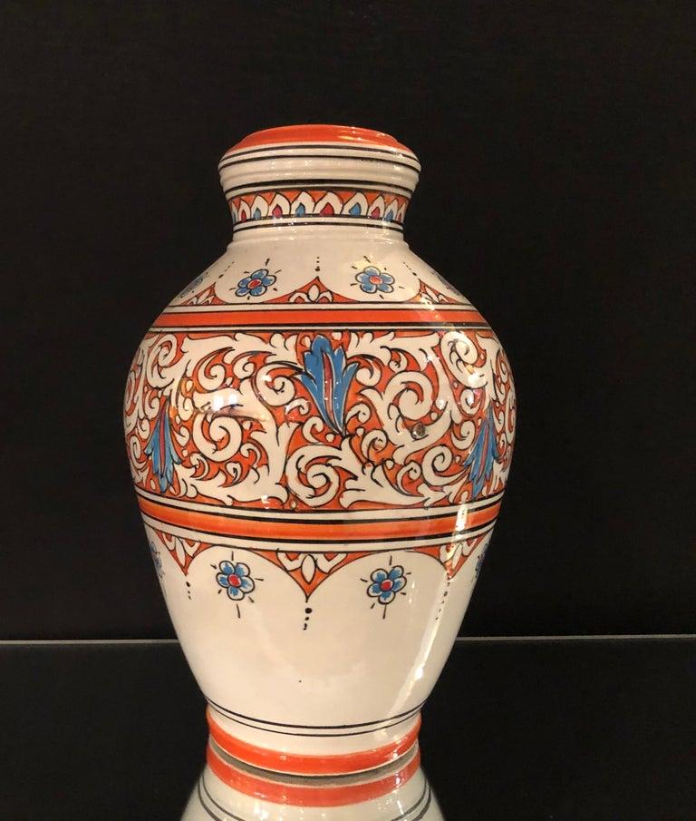 Featuring cool, serene shades of orange and blue and an exquisite hand painted arabesque design, this sumptuous handcrafted ceramic vase provides a breezy elegance to any living space. The vintage vase is in great condition.
Part of a massive