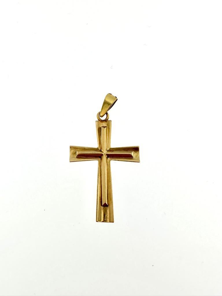 “Simplicity is the keynote of all true elegance.” said Coco Chanel. 
Simple and elegant, this cross is entirely made of 18kt yellow gold. The geometric line of this pendant is reminiscent of 80s fashion. The gold has been polished to bring more