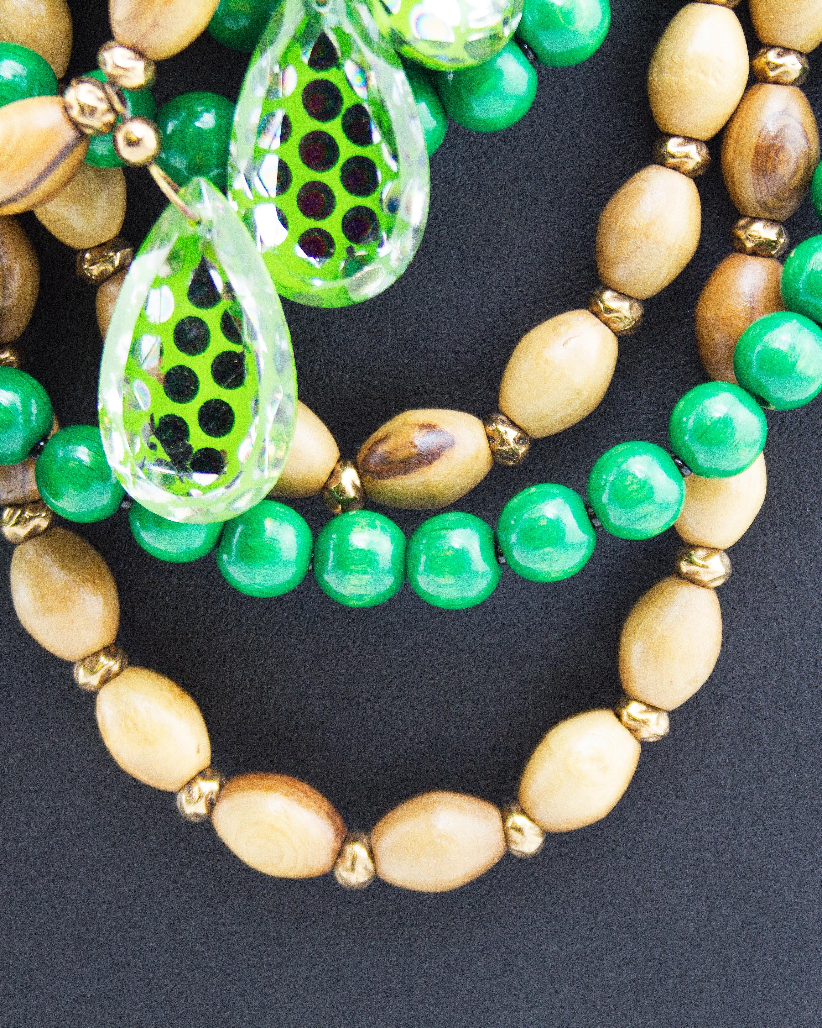 Striking 1980's Yves Saint Laurent Rive Gauche multi strand statement necklace. Dating from the Lou Lou de La Falaise era. Green and light brown wood beads, with large tear drop shaped clear beads with neon green and silver polka dot details. Small