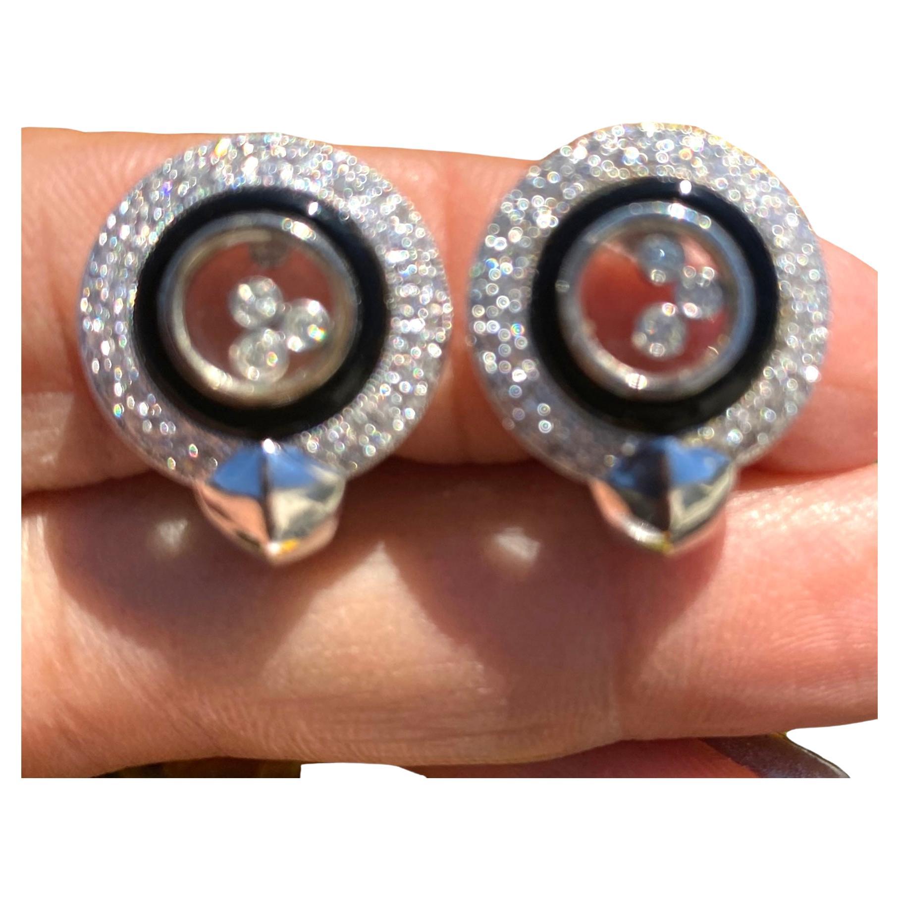 Art Deco Floating Diamond and Black Onyx Earrings 14 Karat White Gold
18 mm diamond earrings are well made with omega backings. 
Quality and durable having a total weight of .80 carats.

Six floating diamonds are set in glass which is a bezel set.