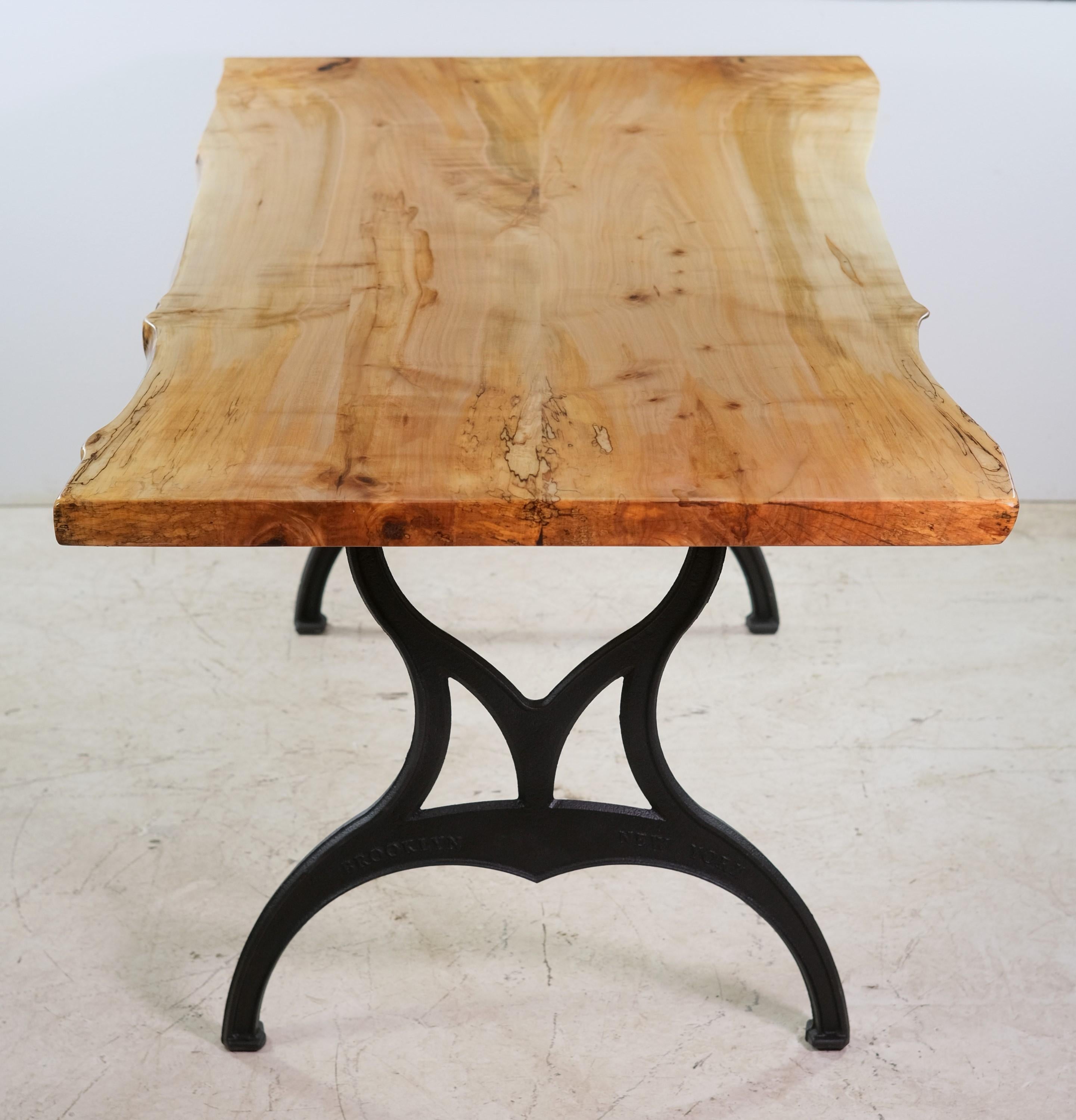 Made in 2022, this two piece live edge maple table top is matched to newly cast iron industrial legs. Each leg says Brooklyn, NY in raised lettering. This can be seen at our 2420 Broadway location on the upper west side in Manhattan.