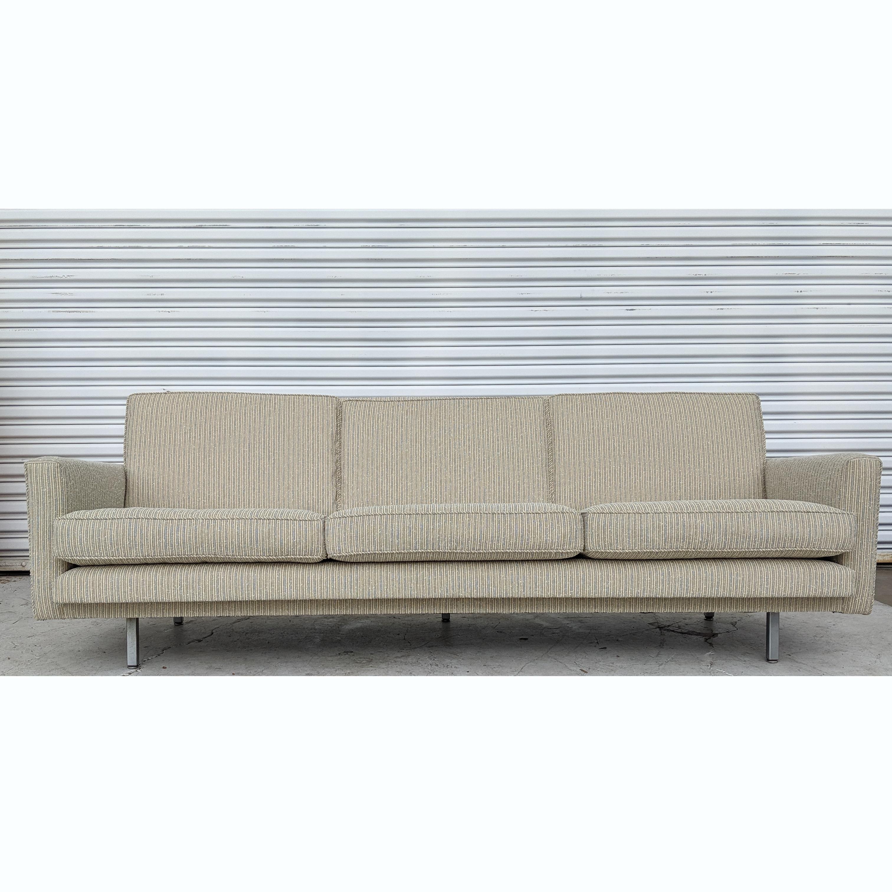 Sofa designed by George Nelson for Herman Miller. Newly upholstered in a ticking striped fabric with chrome legs. Measures: 81