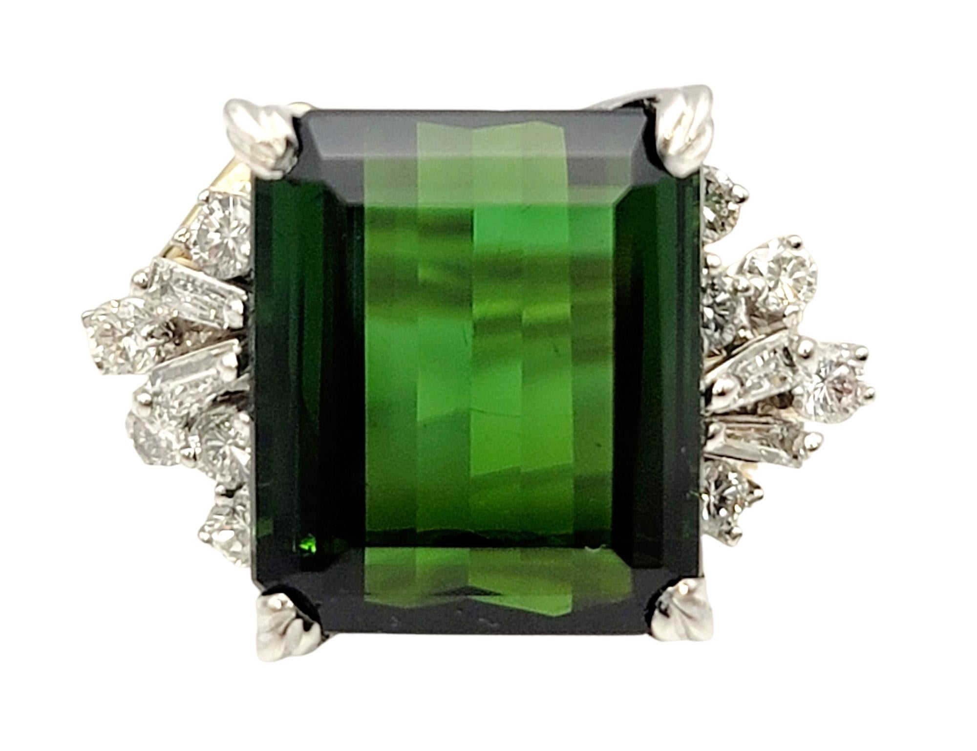 Ring size: 6

Breathtaking green tourmaline and diamond ring. The vibrant green hue of the emerald cut tourmaline pops against the icy white diamonds on either side, while the twisted yellow gold band adds a unique detail to the piece. The elongated