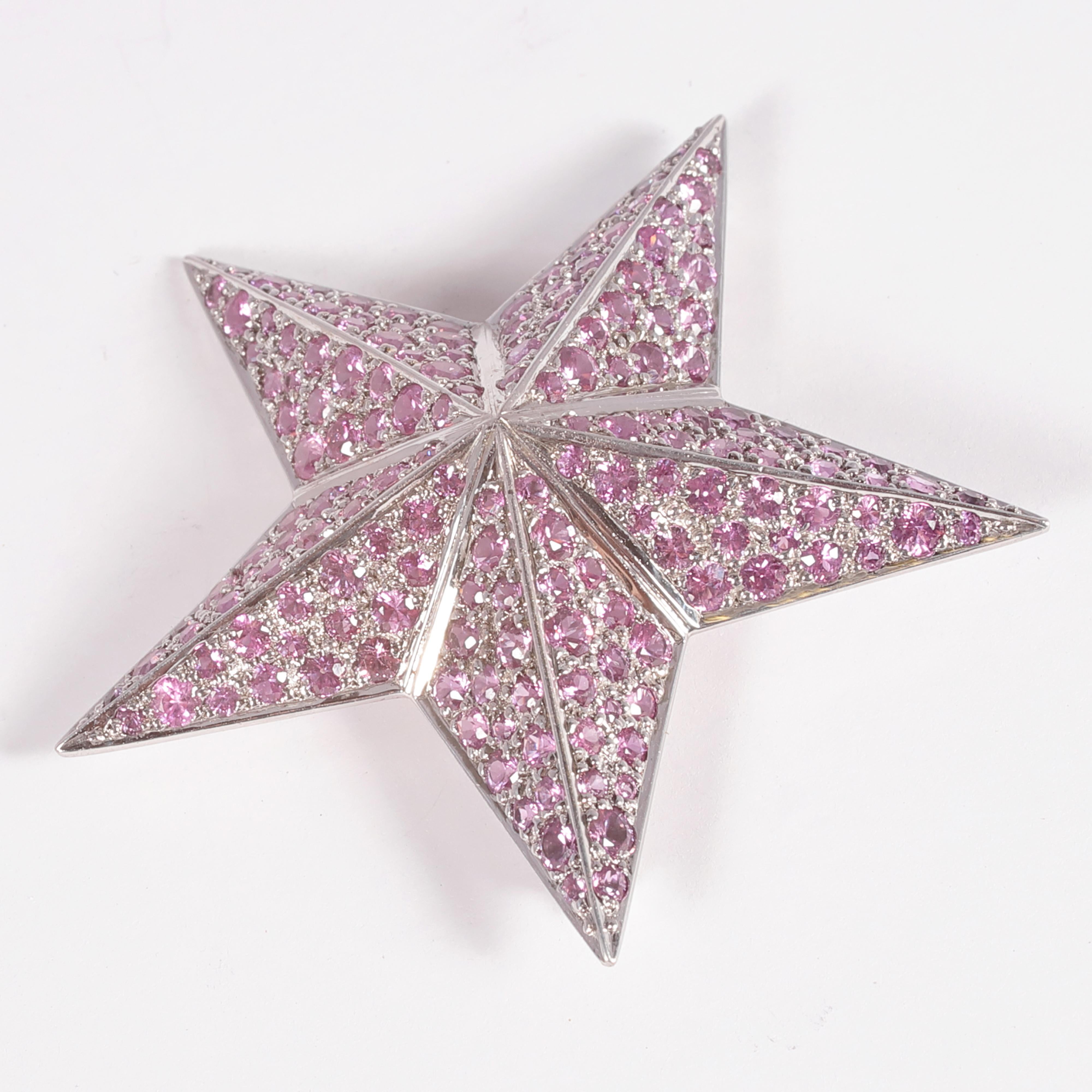Fun statement piece!  This star brooch is in 18 karat white gold and features 8.10 carats of bright pink sapphires. 
Light weight and so pretty!