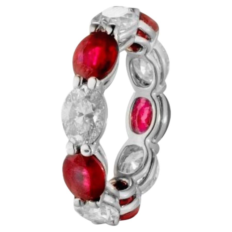 Alternating Oval Shaped Rubies and Diamonds make up this Gorgeous Eternity Band.

5 Rubies weighing 4.45 Carats.
5 Diamonds weighing 3.60 Carats.
Set in Platinum.
Size 6.