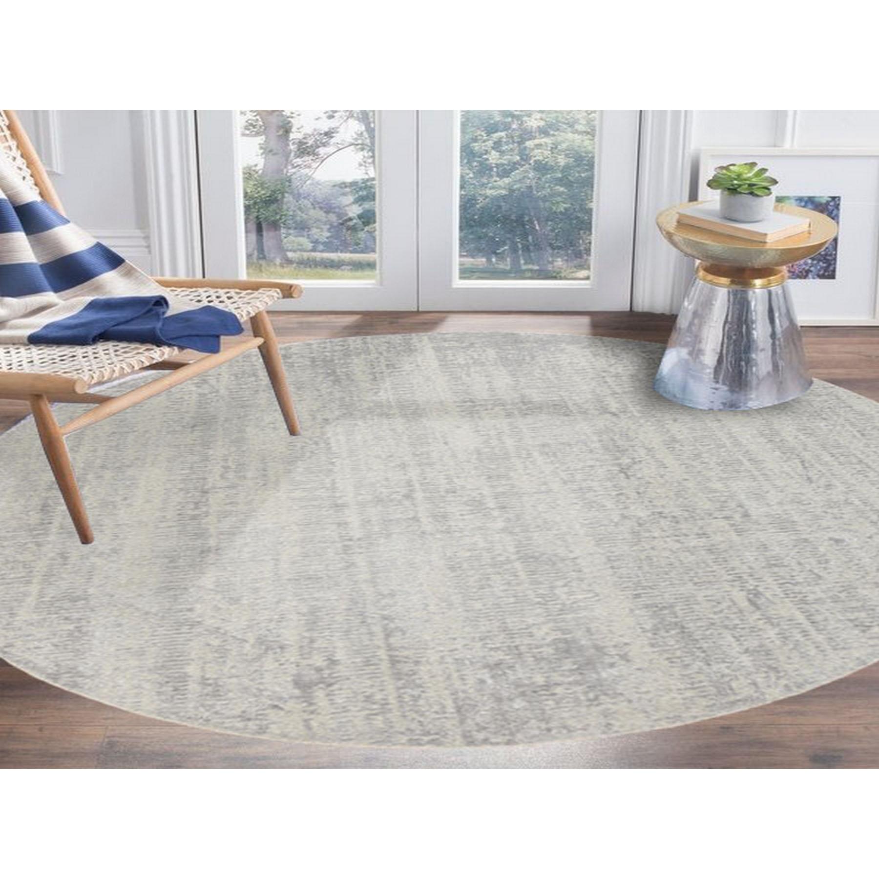 This is a truly genuine one-of-a-kind Gray Fine Jacquard Wool and Plant Based Silk Tone on Tone Hand Loomed Oriental Round Rug. It has been Loomed for months and months in the centuries-old weaving craftsmanship techniques by expert